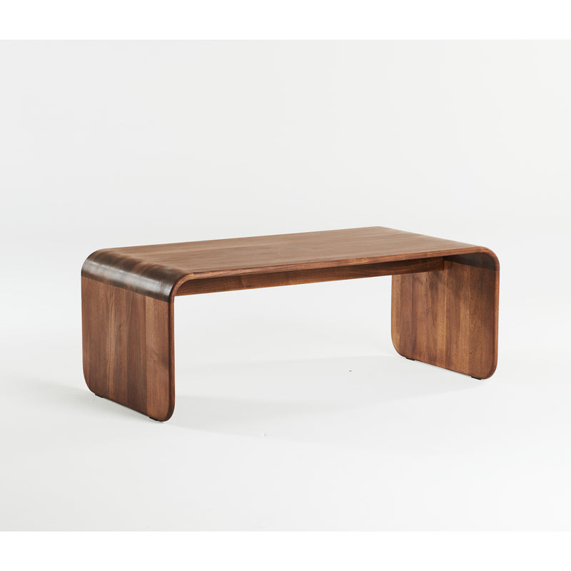 The ENY Coffee Table by Artisan features a sleek and minimalist design. Crafted from solid wood, it has a smooth curved top with rounded edges supported by two flat curved legs, seamlessly blending into the tabletop. It’s finished with natural oils for a warm, rich brown hue.
