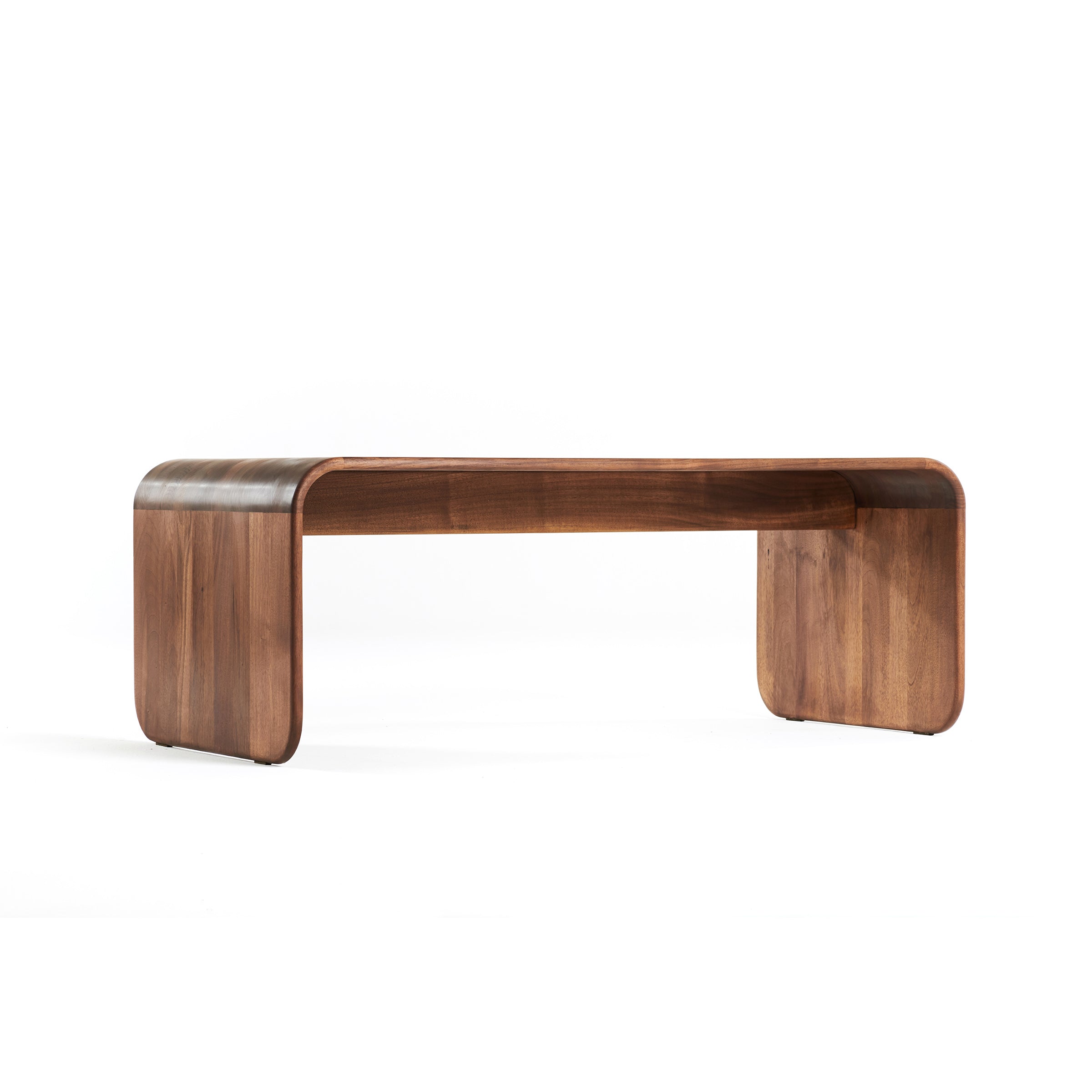 The ENY Coffee Table by Artisan is a modern piece with a smooth, minimalist design. Crafted from solid wood, it features a natural wood grain finish enhanced by oils. Its rounded corners ensure a sleek and eco-friendly contemporary appearance.
