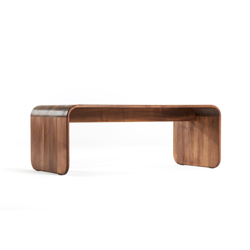 The ENY Coffee Table by Artisan is a modern piece with a smooth, minimalist design. Crafted from solid wood, it features a natural wood grain finish enhanced by oils. Its rounded corners ensure a sleek and eco-friendly contemporary appearance.