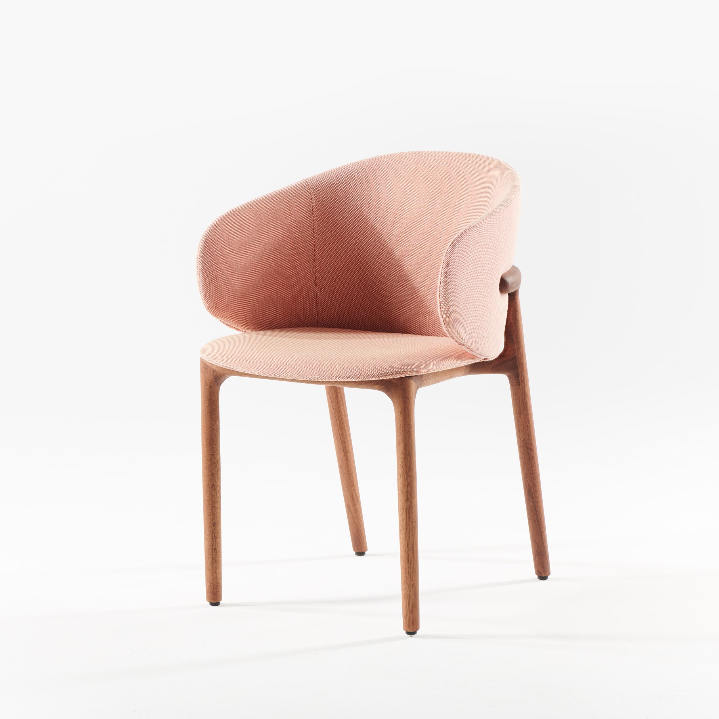 Introducing the Artisan Mela Chair, a modern masterpiece featuring a light pink upholstered backrest and seat. Its minimalist wooden frame with smooth, rounded edges and elegantly curved legs exudes mid-century charm.
