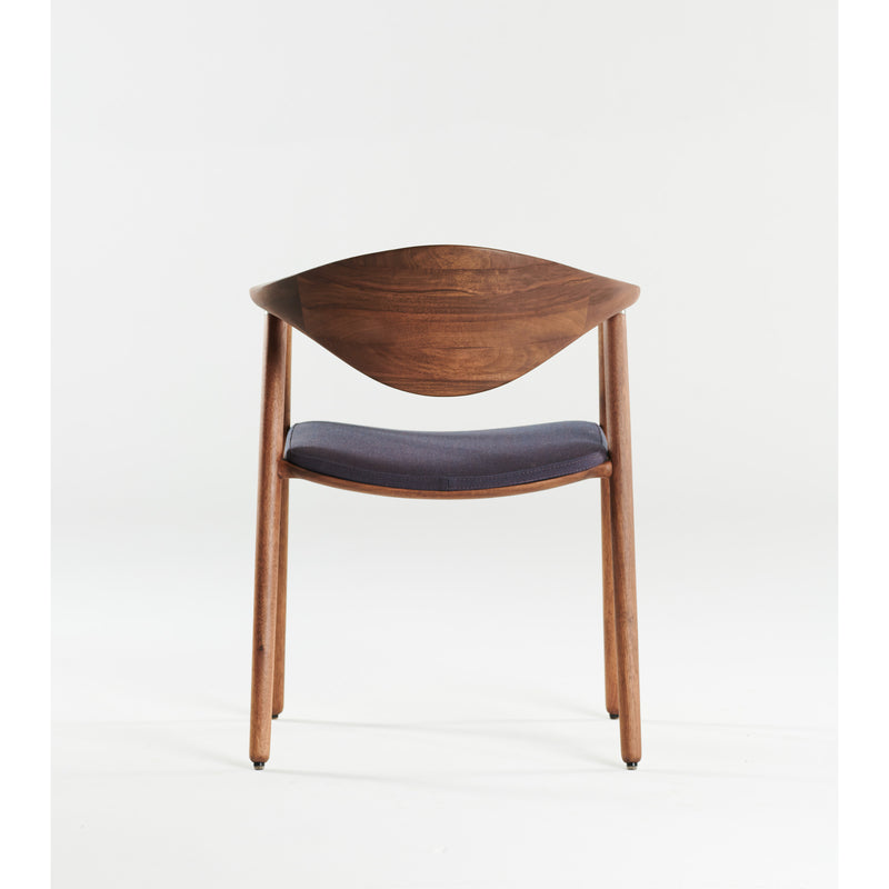 The NARU Chair by Artisan features a minimalist design with an upholstered seat and curved backrest, crafted from solid wood and treated with natural oils. Its dark fabric and eco-friendly appeal are highlighted against a plain white background.
