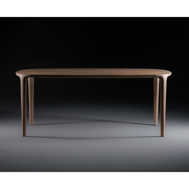 The WU Table by Artisan is a sleek, modern dining piece featuring a smooth oval top and four slender legs. Crafted from solid wood, its luxurious texture stands out beautifully against dark backgrounds, adding elegance to any dining space.