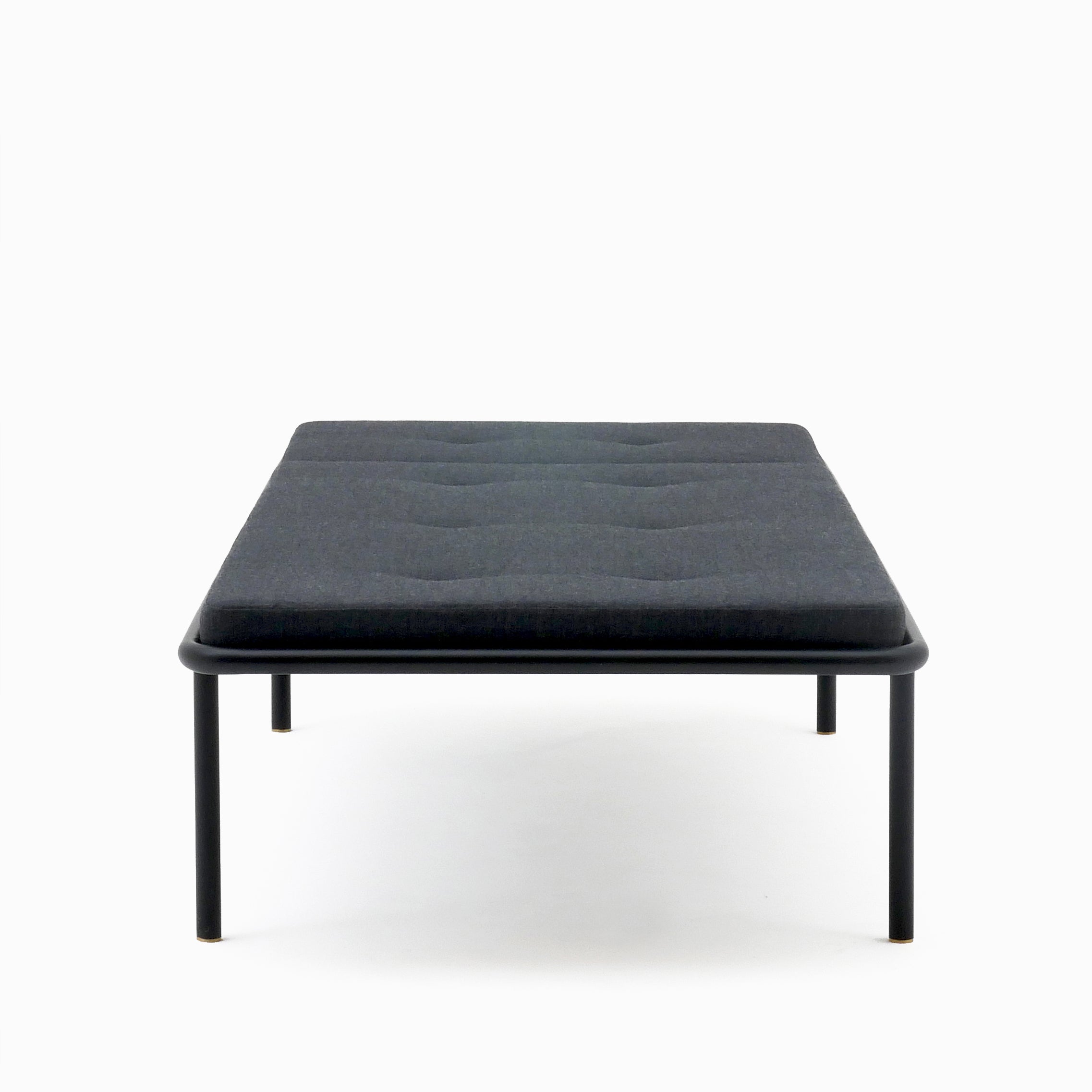 2PM Day & Night Daybed with black steel frame and gray upholstered mattress on minimalist industrial design base