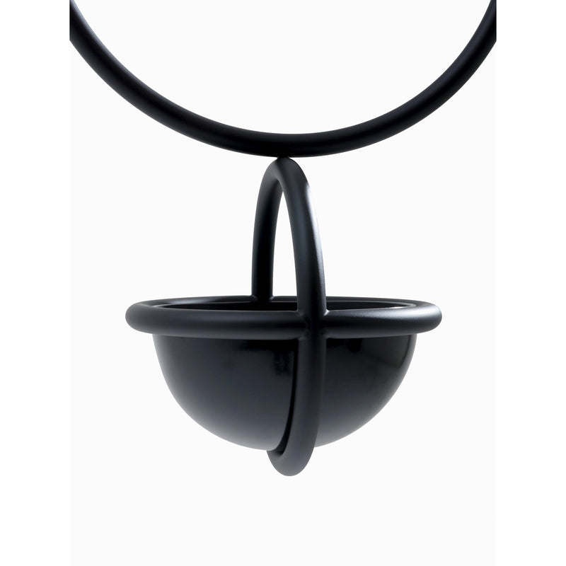 The Blumenkugel - Hanging Flower Bowl by Atelier Haussmann is a minimalist black powder-coated steel pendant with intersecting loops. It hangs elegantly on a matching cord against a white backdrop, showcasing its glossy finish and geometric design.