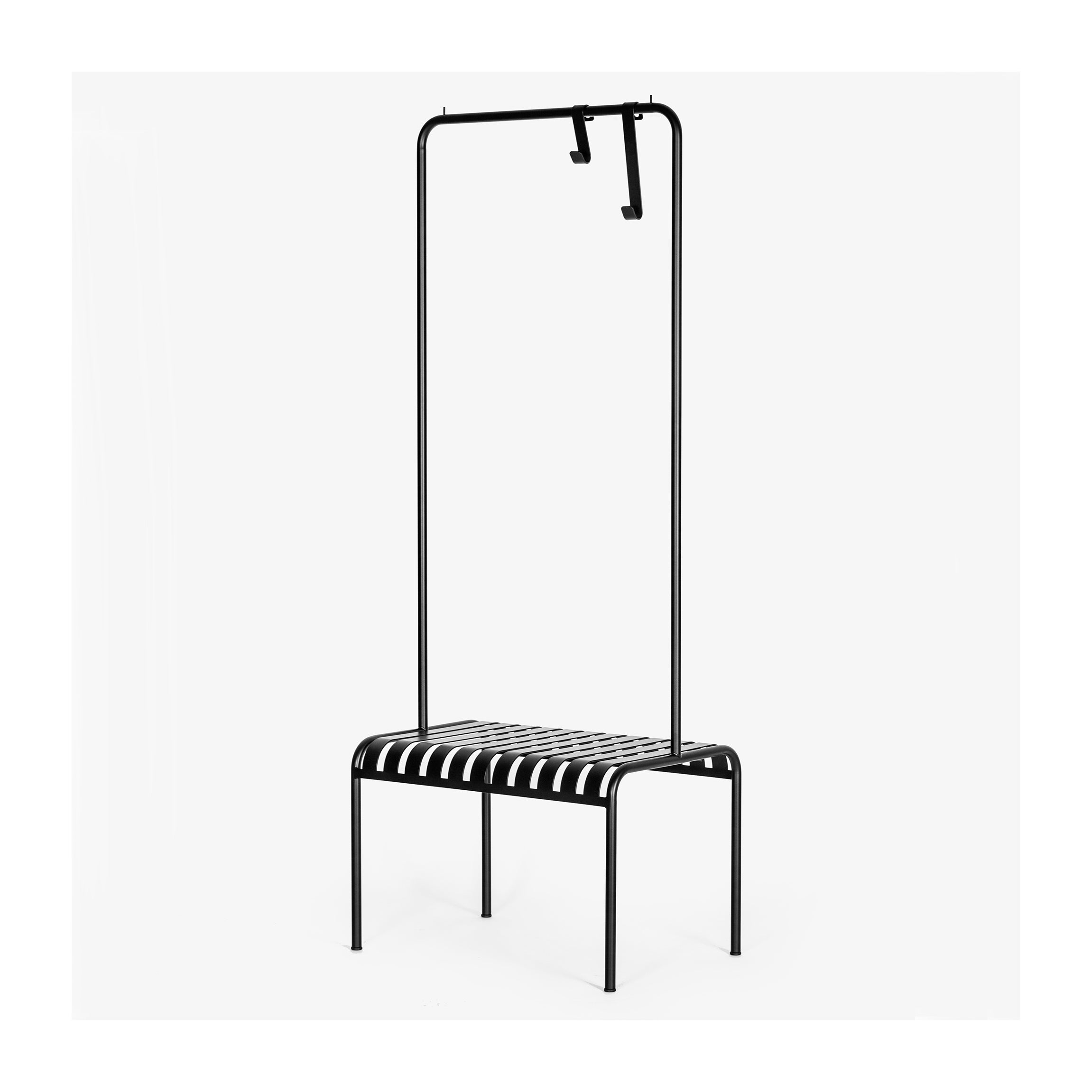 The YOUTOO is a minimalist black metal bench from Atelier Haussmann, crafted in sleek powder-coated steel with a slatted design. It features a tall frame with two hooks on the top bar, all set against a plain white background.