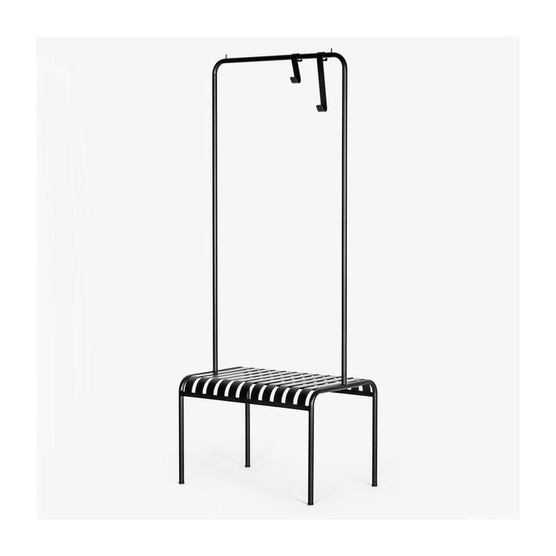 The YOUTOO is a minimalist black metal bench from Atelier Haussmann, crafted in sleek powder-coated steel with a slatted design. It features a tall frame with two hooks on the top bar, all set against a plain white background.