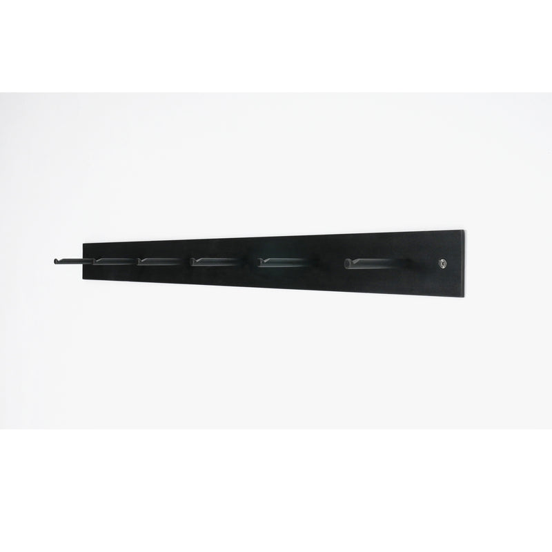 Atelier Haussmanns HELLOGOODBYE coatrack, crafted from white powder-coated steel and featuring five evenly spaced pegs, is mounted on a white wall. This black coatrack combines sleek design with minimalist and modern aesthetics.