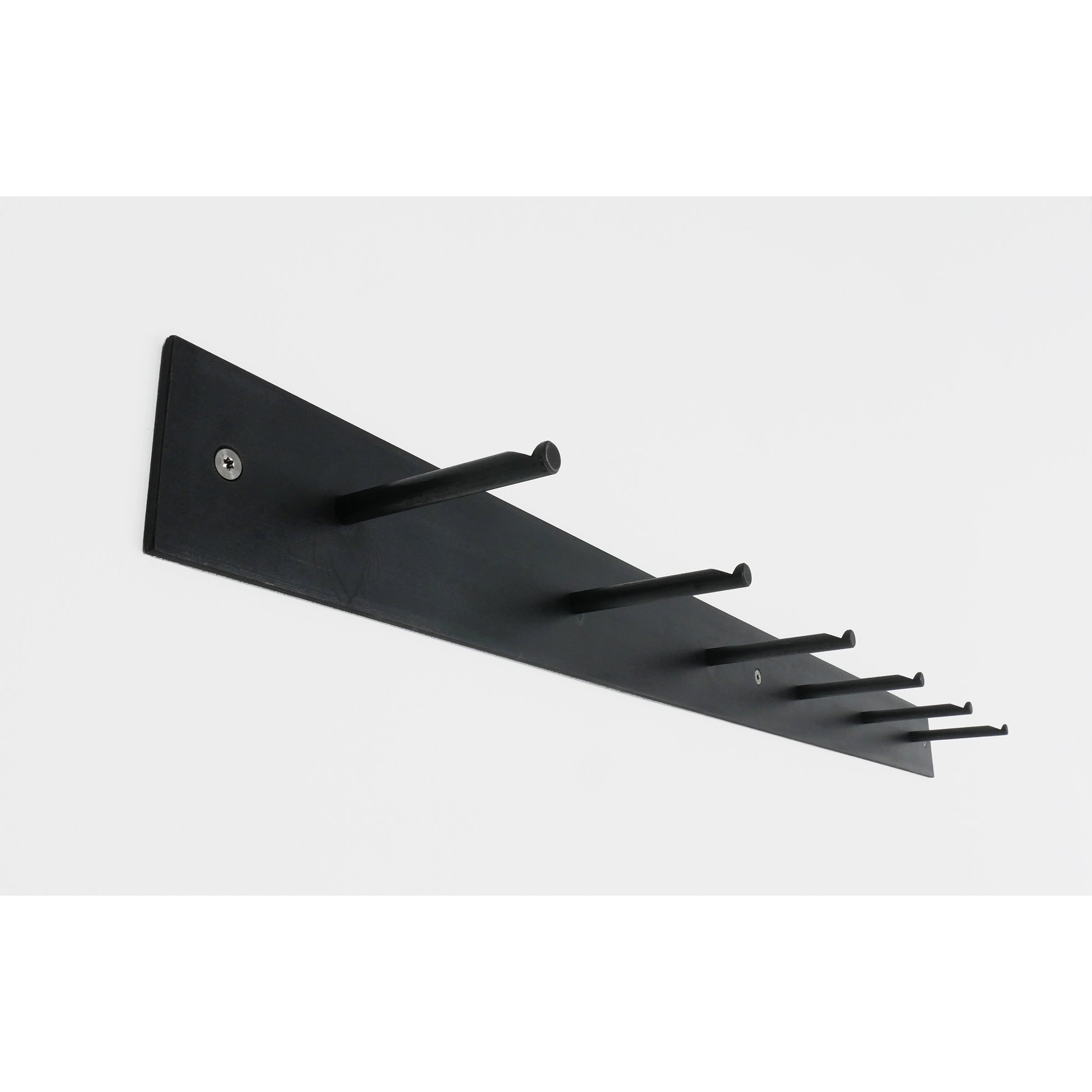 The HELLOGOODBYE by Atelier Haussmann is a black wall-mounted coat rack, featuring five evenly spaced horizontal hooks on a flat rectangular base. Its secured with visible screws, shown from a side angle against a white background for an elegant contrast.