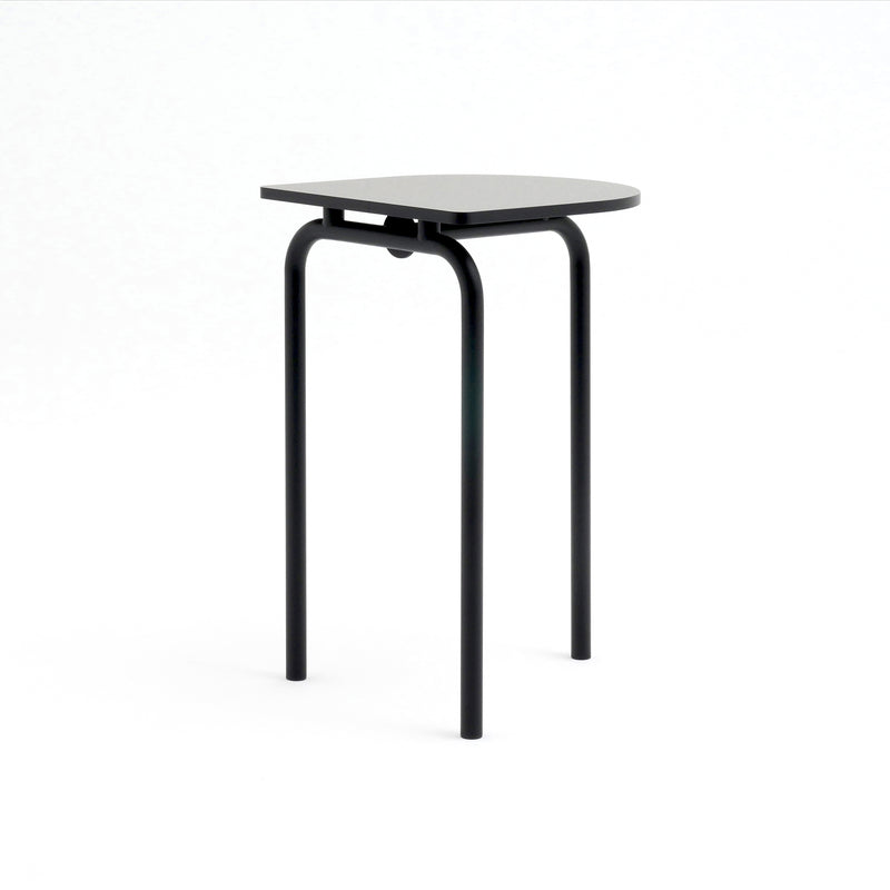 The Piombino Alto 700 by Atelier Haussmann is a minimalist black stool featuring a flat, slightly rounded square seat and three slender legs. Its industrial design complements the PIOMBINO table, set against a plain white background, perfect for any contemporary space.