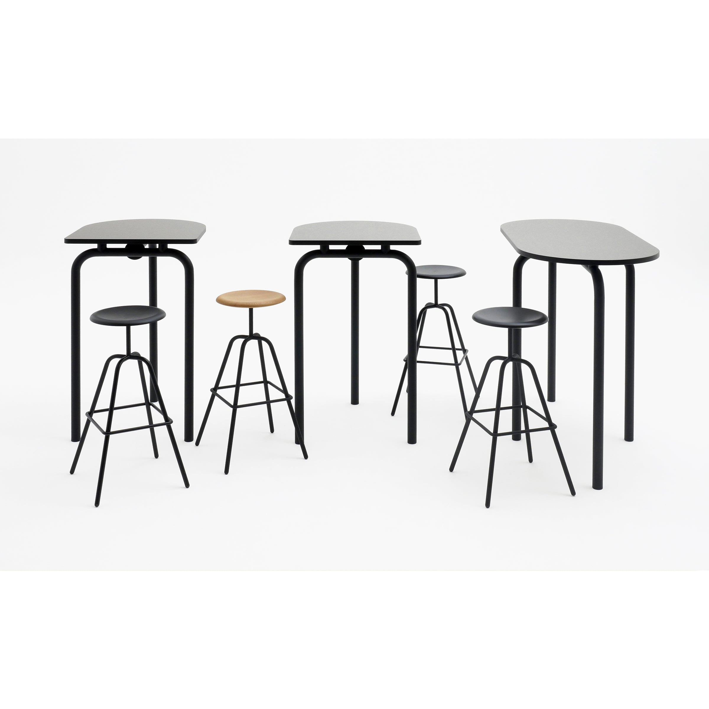 Uncover the PIOMBINO ALTO 1267 by Atelier Haussmann, a table collection where modern high tables and stools fuse minimalist and industrial vibes. Tables flaunt black rounded legs with grey tops, while stools showcase sleek black metal legs with round black and wood seats.