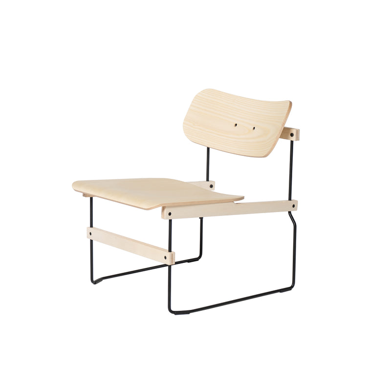 The Brutissimo by Moormann is a minimalist lounge chair with a molded wood seat and backrest featuring curved edges. It has thin black steel wire legs, creating a simple, modern design that complements any space.