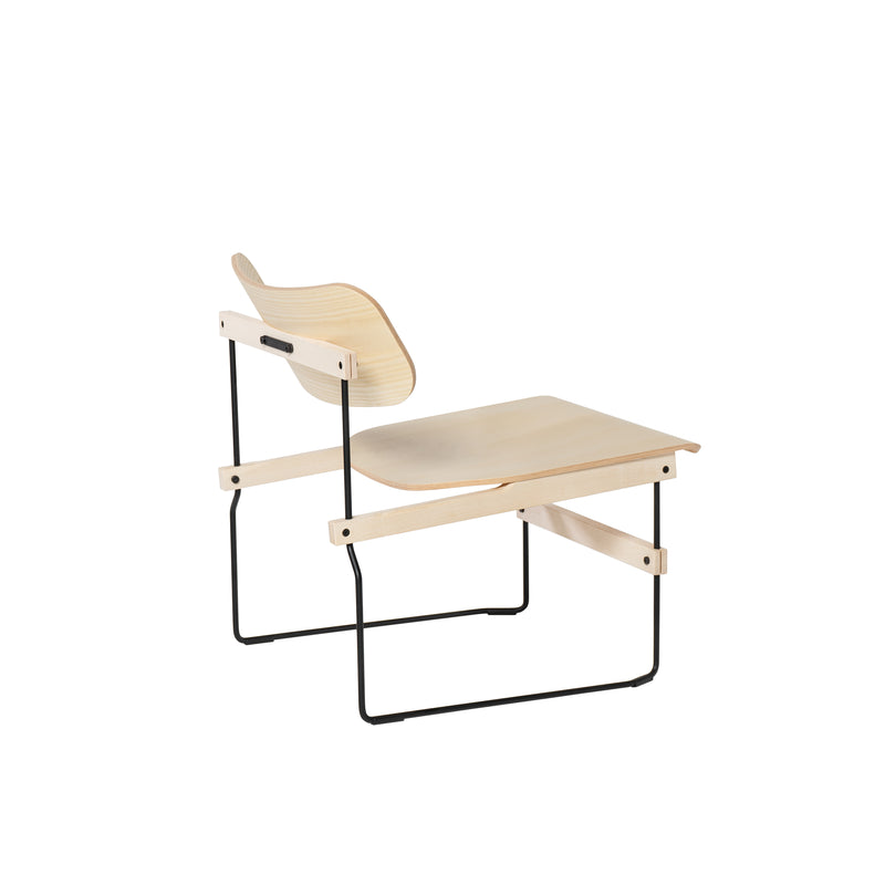 The Brutissimo by Moormann is a modern lounge chair with a molded wood seat and backrest, set on sleek black steel wire legs. Its minimalist design showcases clean lines and a contemporary aesthetic against a plain white background.