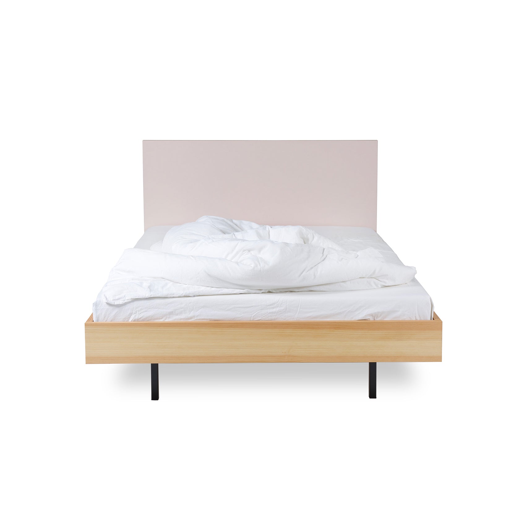 Introducing the Unidorm Bed Powder by Bartmann Berlin: A minimalist double bed with a wooden frame made from oiled pine, a beige headboard, and white bedding featuring a slightly rumpled comforter and pillows set against a simple white backdrop.