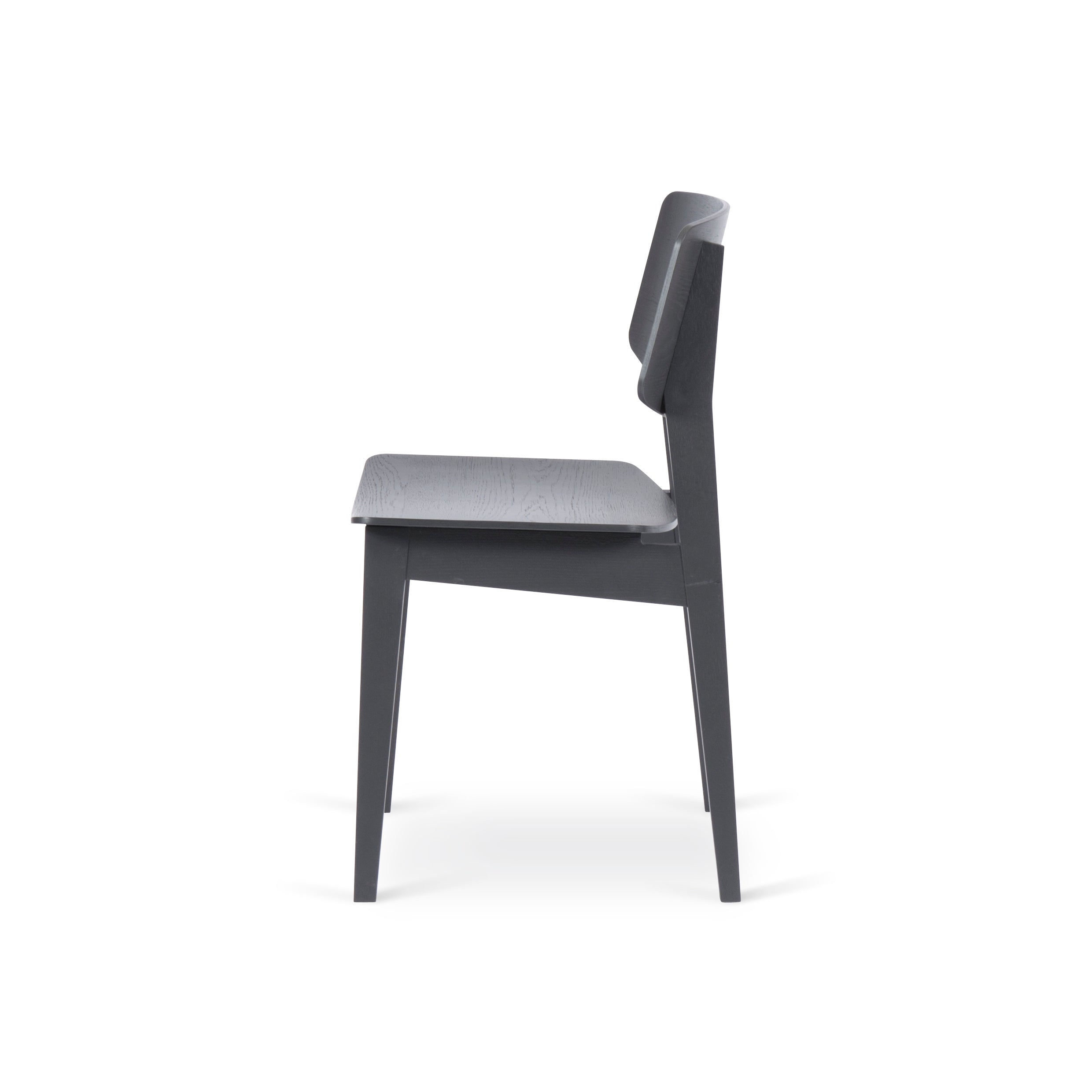 Side view of the Bartmann Berlin Usus Chair with a minimalist design and natural elegance, showcasing a modern black finish, straight backrest and seat, clean lines, and four oak legs against a plain white background.
