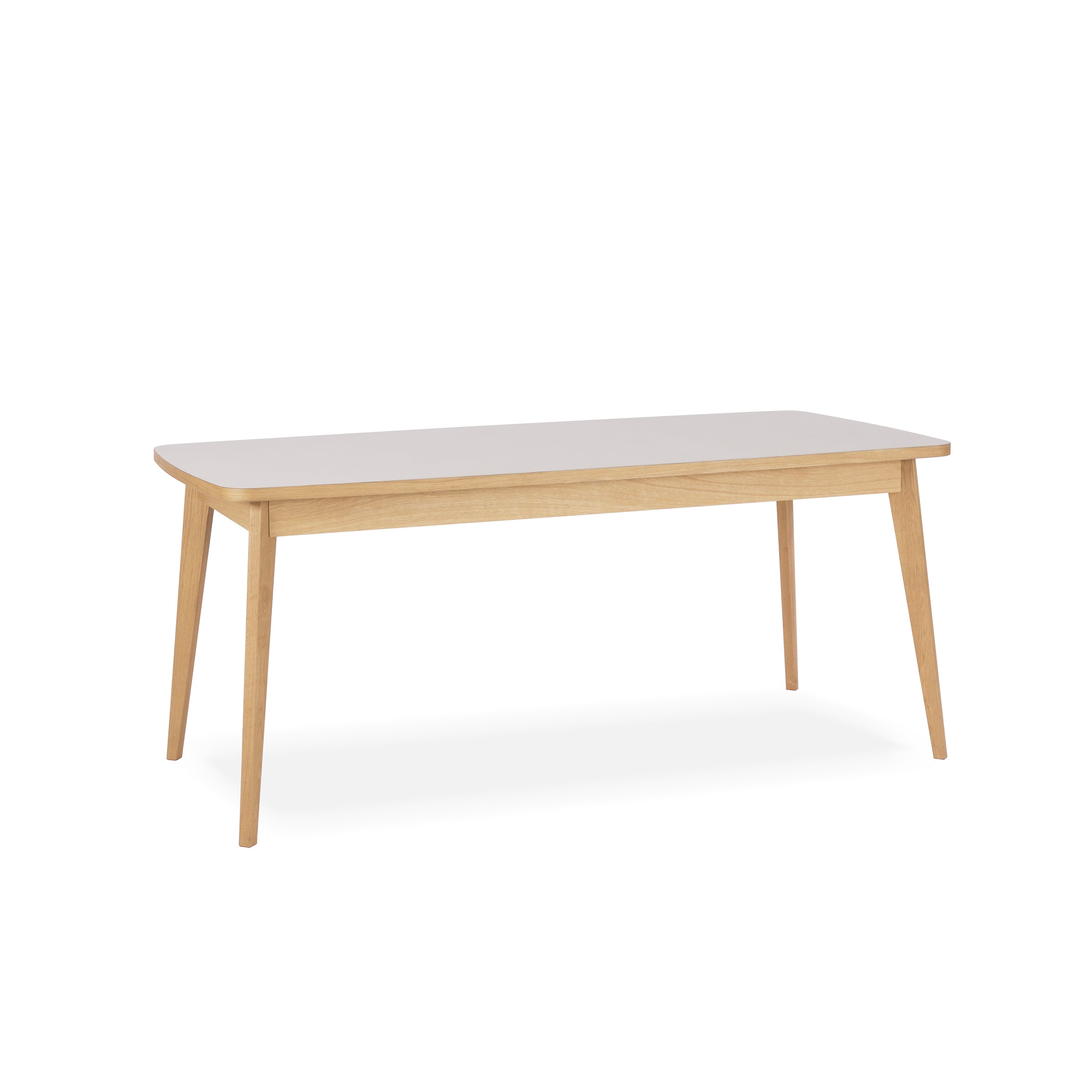 The Usus Table by Bartmann Berlin is a wooden dining table made from European oak, featuring a rectangular top with rounded edges and four tapered legs. Its light, natural finish complements any space, making it an elegant centerpiece for dining experiences.