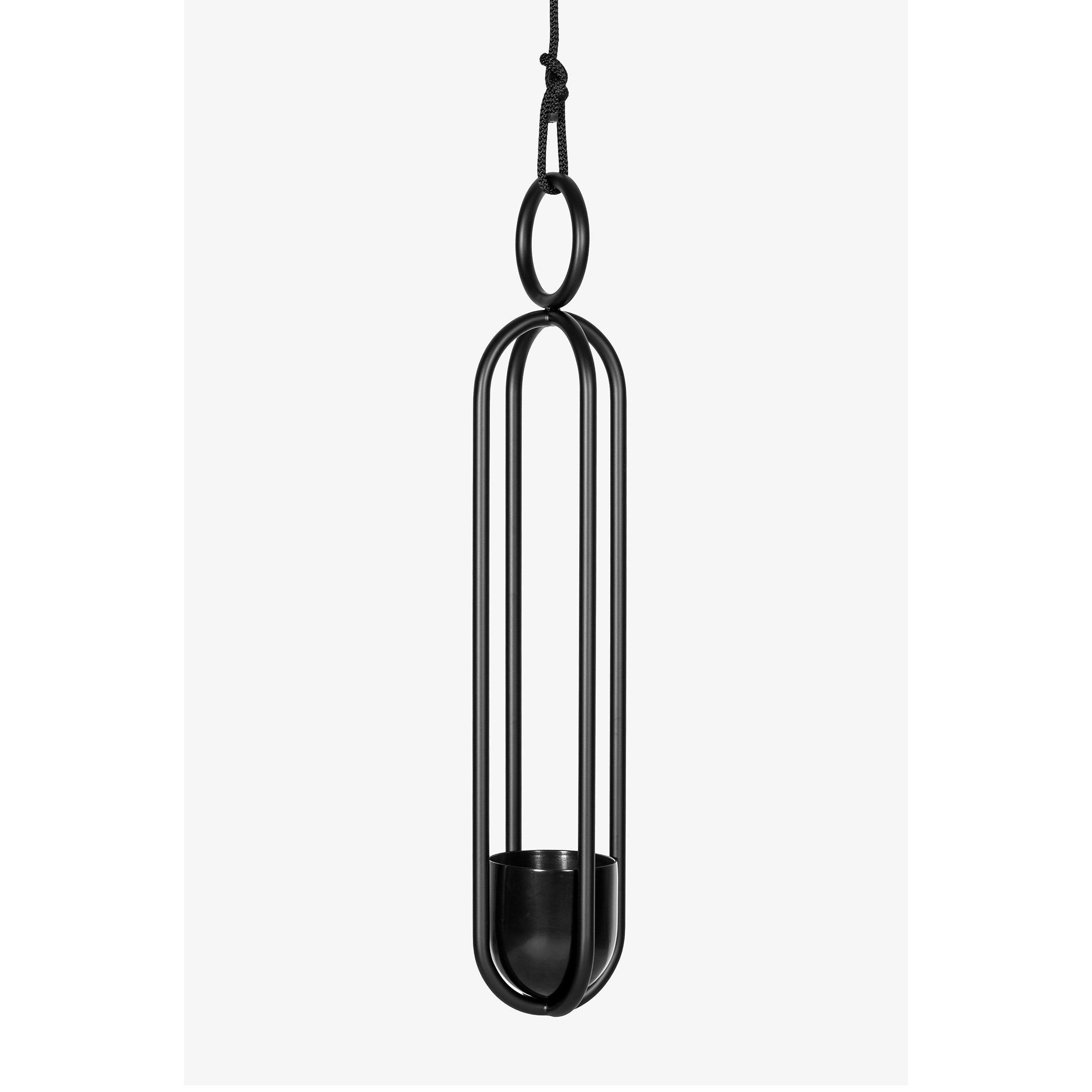 The Blumenampel - Hanging Flower Vase by Atelier Haussmann is a minimalist black metal piece with sleek, elongated vertical bars, a circular top loop, and a small flower holder. Suspended by a black cord, it adds sophistication to any space.