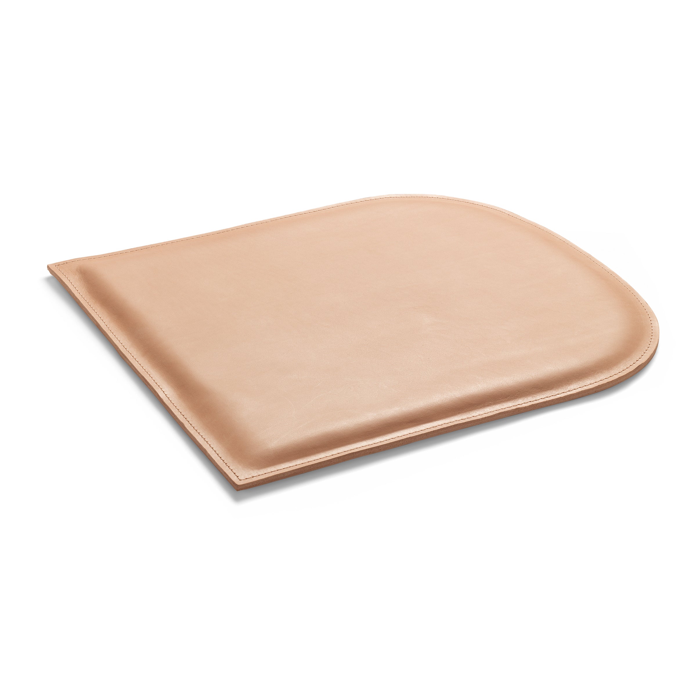The E15 CU10 GAMAR Cushion, tan in color, boasts a curved top edge and straight sides with a smooth, slightly glossy finish reminiscent of harness leather, displayed against a white background.