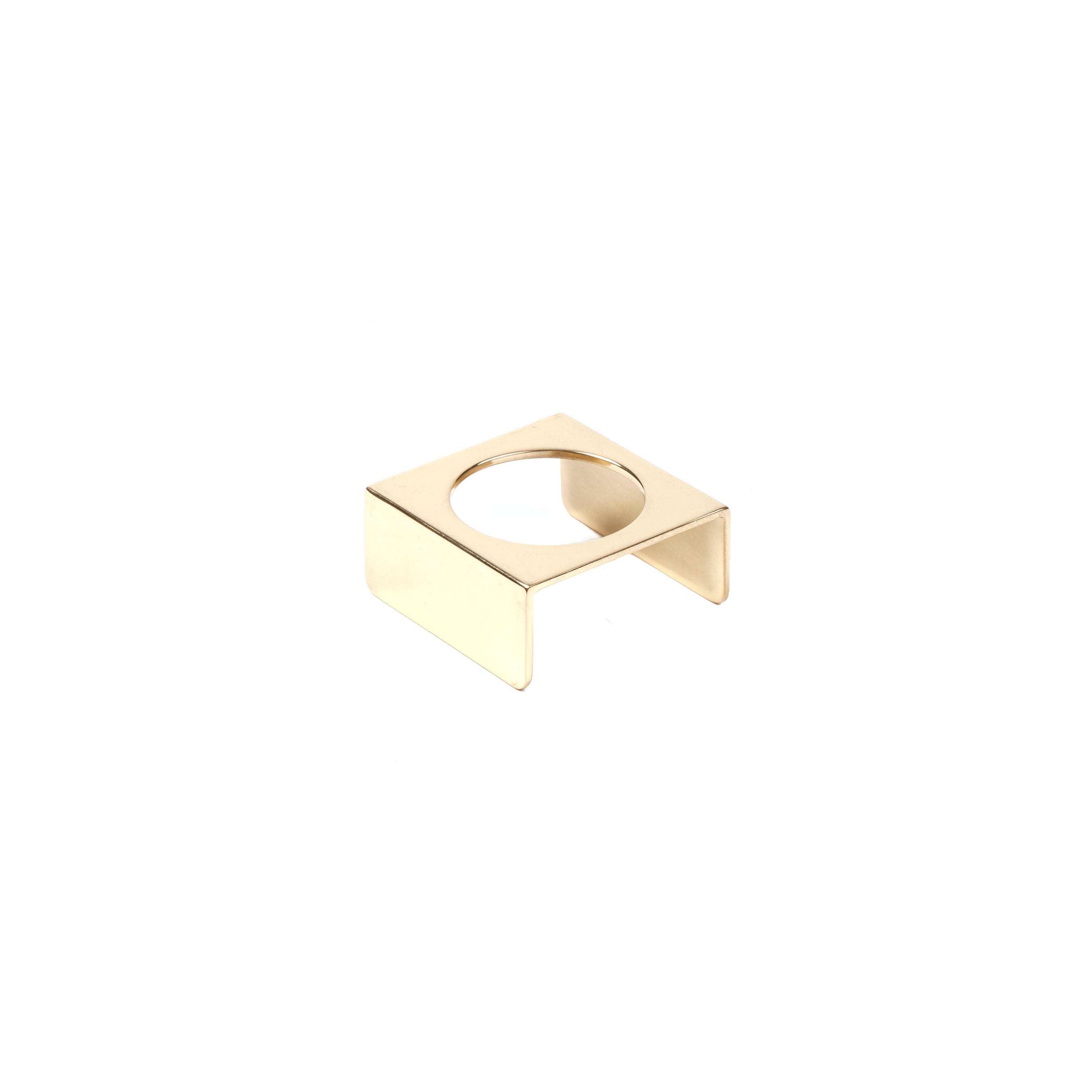 An Egg Cup #7230 by Werkstätte Carl Auböck, embodying the brands clean lines and minimalist design, features a gold square shape with an open circular center. It rests on a white background, echoing modern aesthetics.