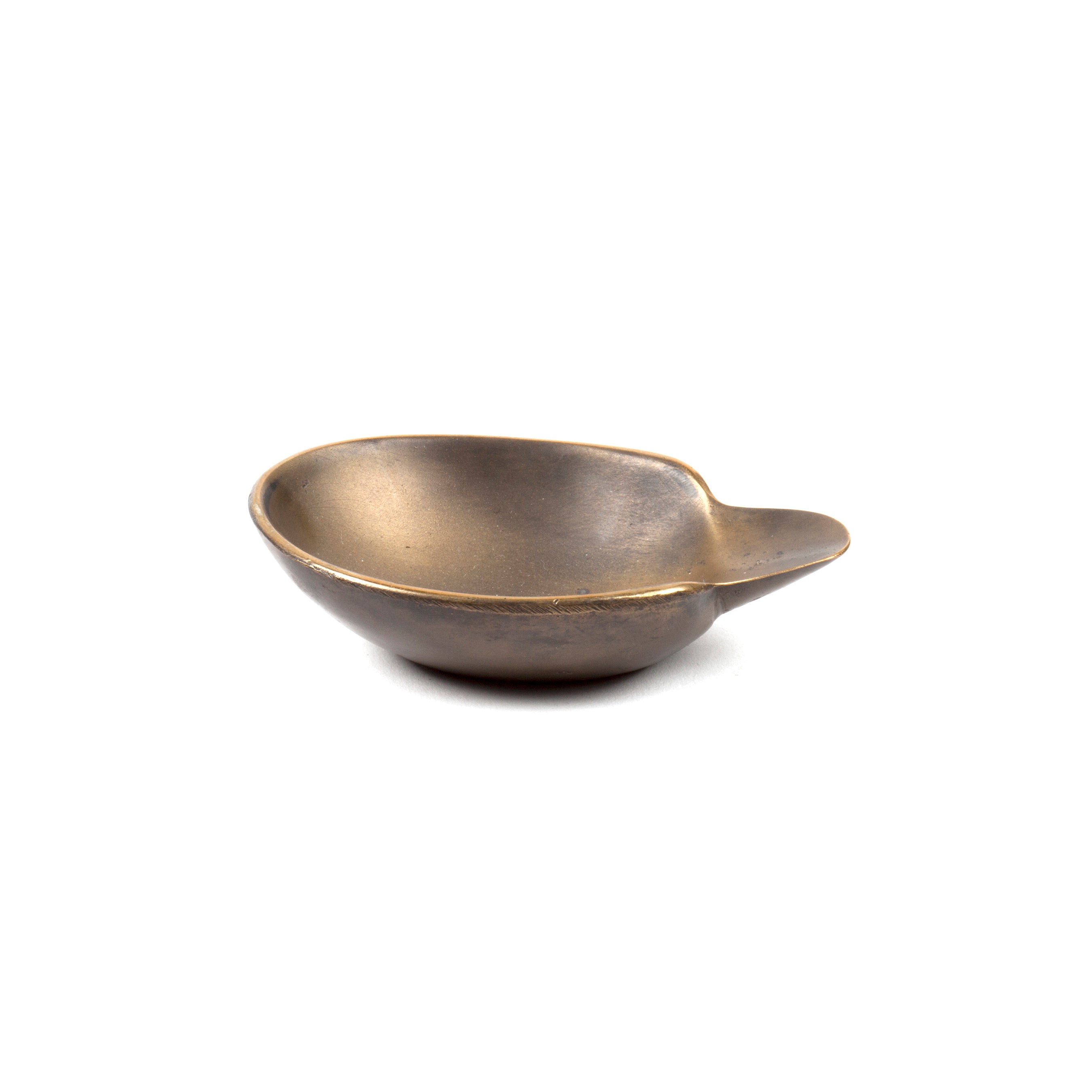 A shallow, bronze metal dish with a side handle evokes Wiener Bronzen craftsmanship and is set on a plain white background. This elegant piece is the Dish #3599 by Werkstätte Carl Auböck.