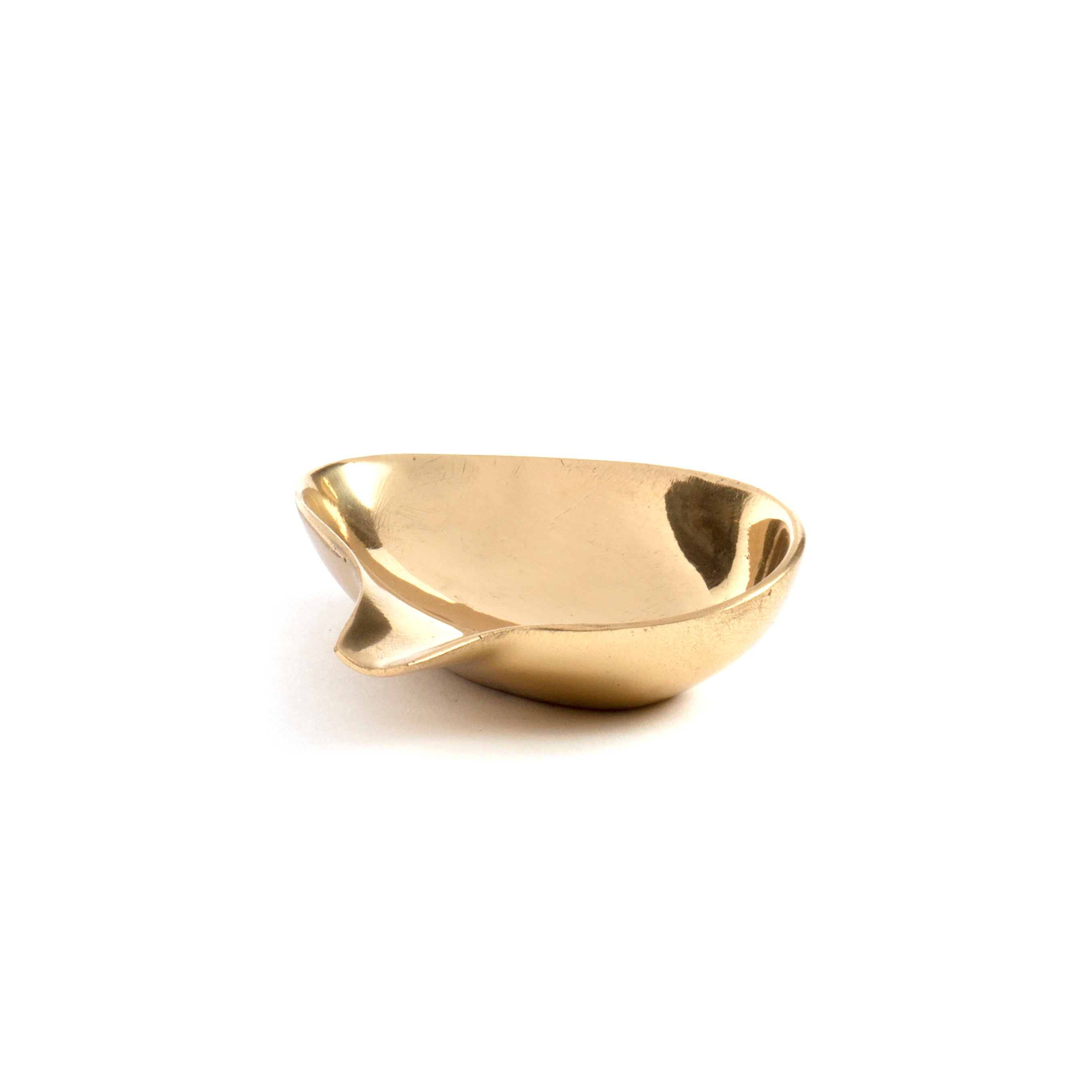 Dish #4206B, a small shiny brass bowl with a spout by Werkstätte Carl Auböck, sits against a plain white background, exuding modern elegance reminiscent of Viennese townhouses.