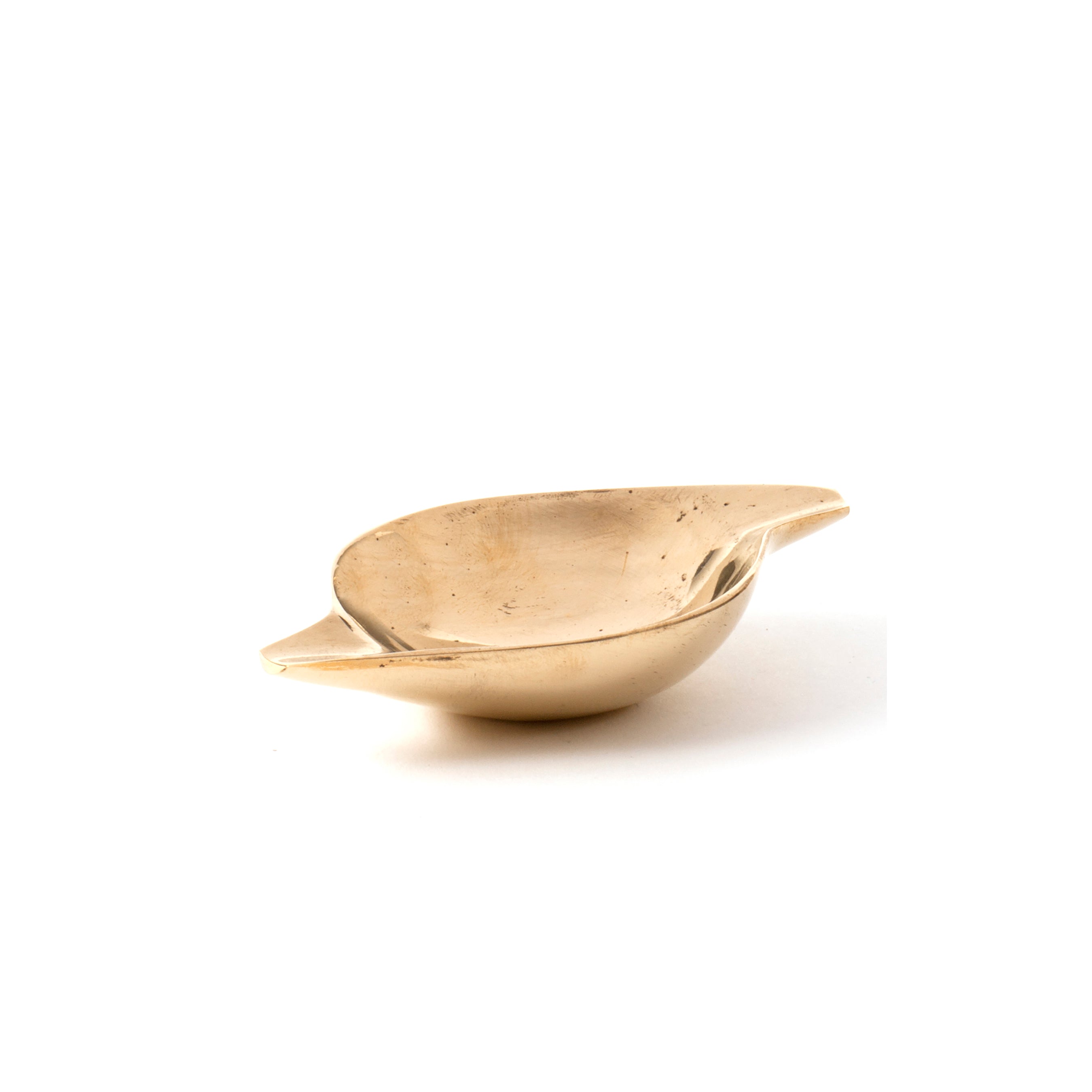 The Ashtray #4206C by Werkstätte Carl Auböck is a small, shallow brass bowl with a polished surface and two wide handles on the rim, reflecting elegant design against a plain white background.