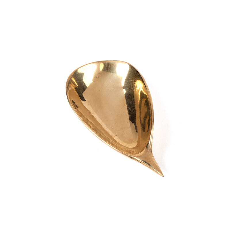 Dish #4206A by Werkstätte Carl Auböck is a teardrop-shaped, polished brass spoon with a smooth, curved handle and an elegant, reflective surface set against a white background.