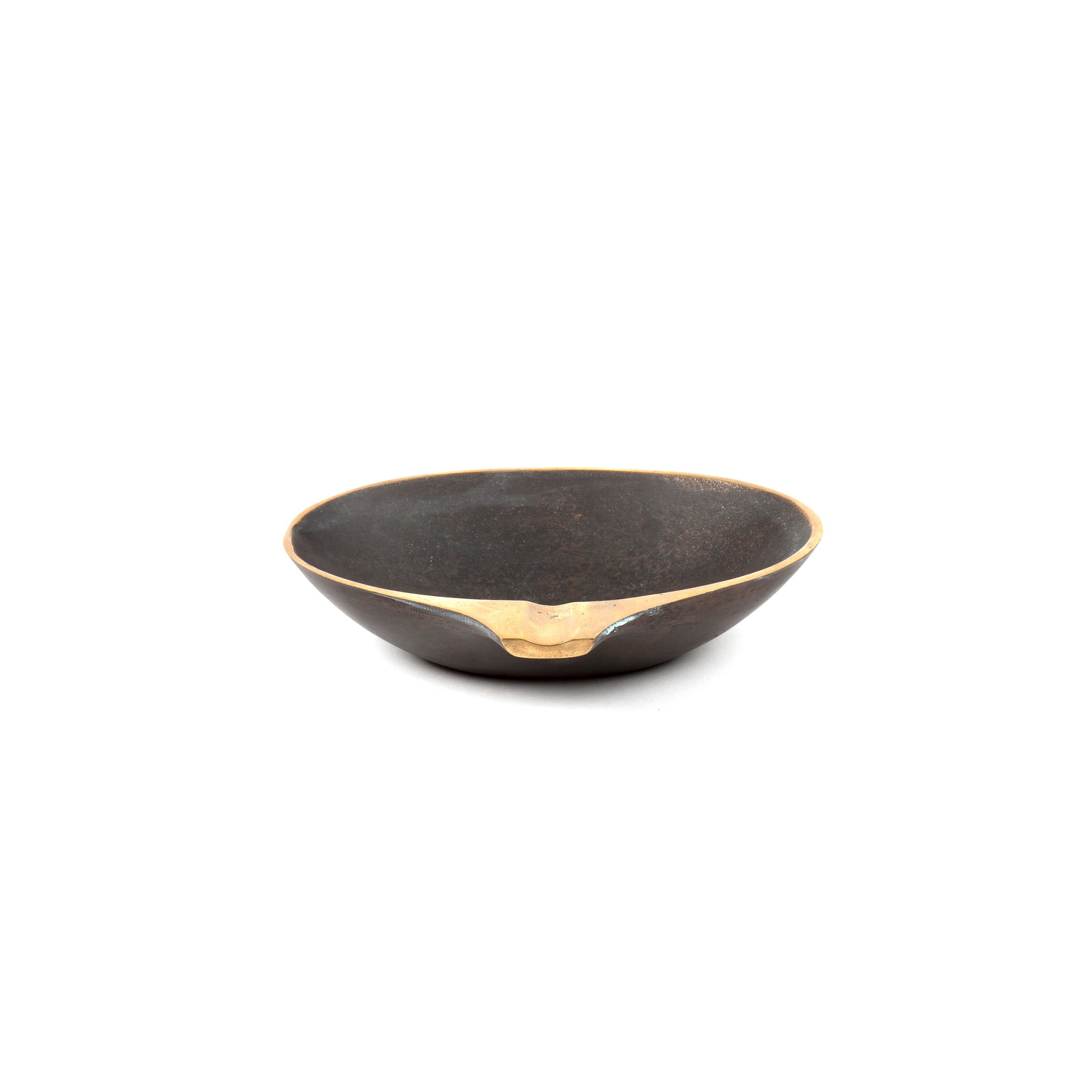 Dish #4308 by Werkstätte Carl Auböck is a round, shallow, black ceramic bowl with a smooth texture and an irregular metallic gold accent on the rim, highlighted against a plain white background.