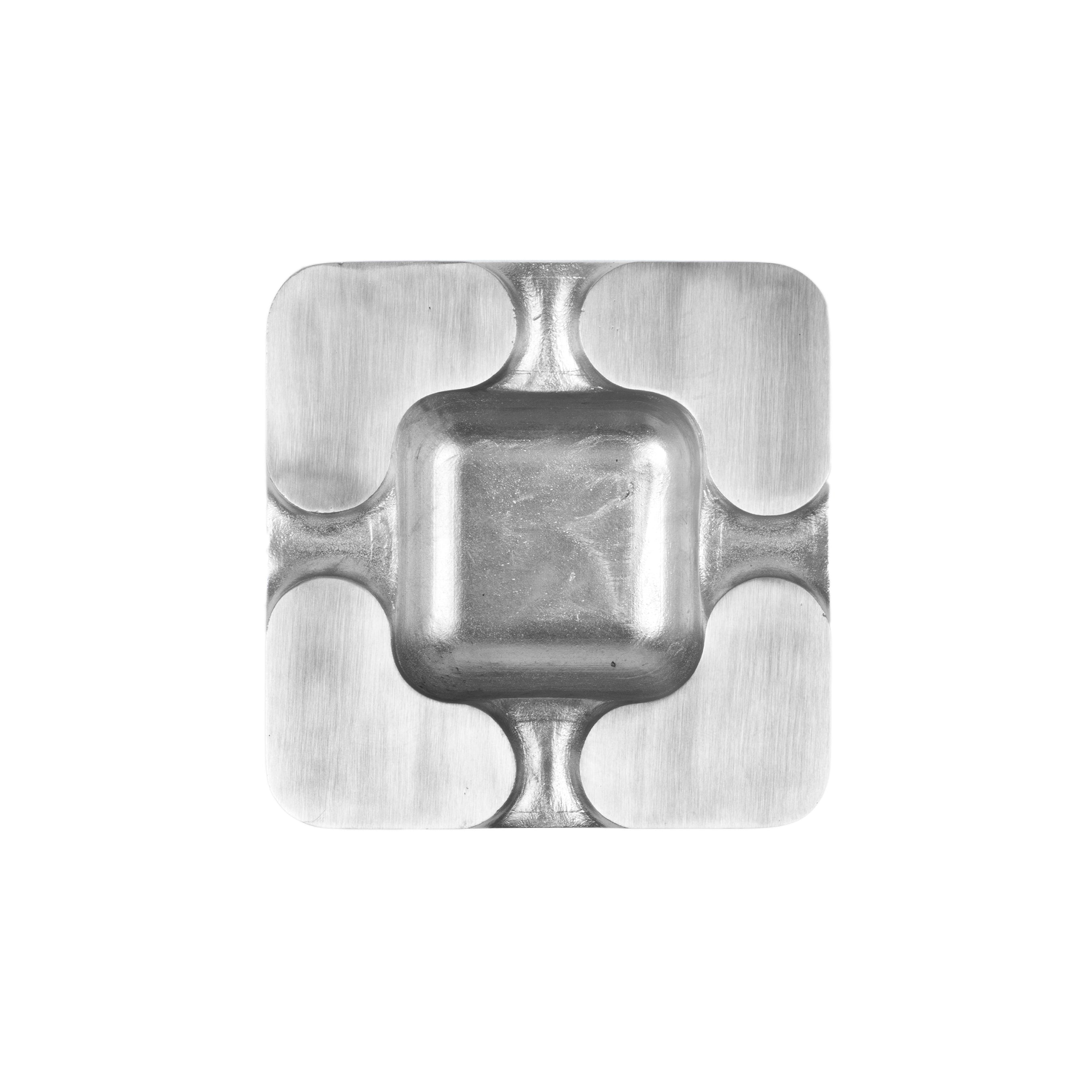 The Ashtray #5556-2 by Werkstätte Carl Auböck features a minimalist design with rounded edges and four corner hooks, enhanced by a brushed metallic texture that exudes modern elegance.