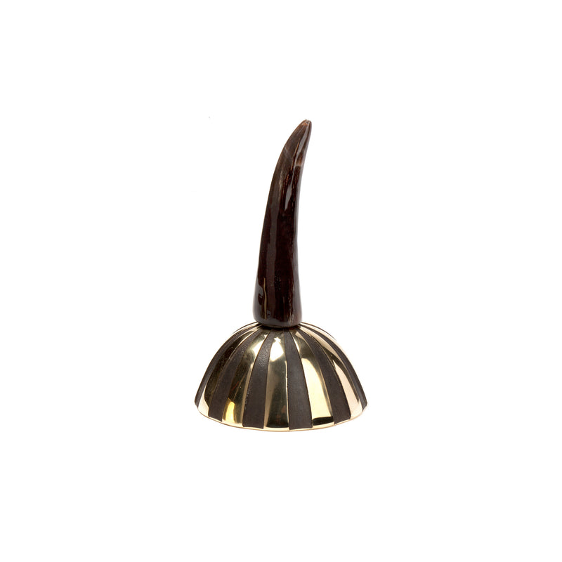 The Bell Zebra #3604 by Werkstätte Carl Auböck is a black and gold sculptural piece, recalling Viennese craftsmanship, featuring a shiny, horn-like curved top on a striped, dome-shaped base against a white backdrop.