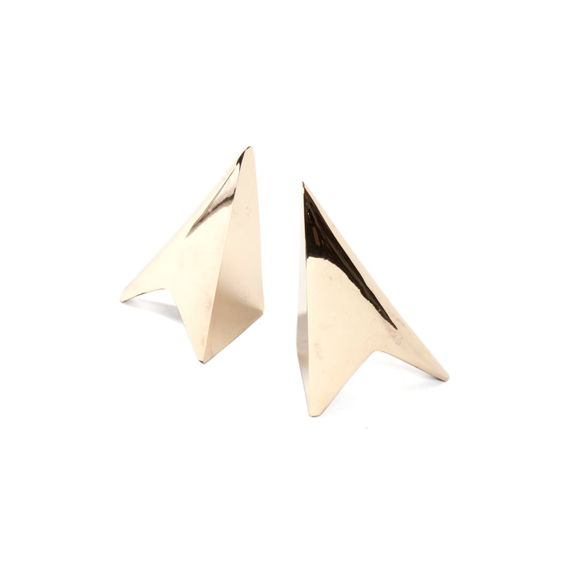 The Pair of Bookends #3846 by Werkstätte Carl Auböck, designed in a polished gold modernist style, resemble stylized paper airplanes. They stand upright on a white background, highlighting their sleek, angular design.