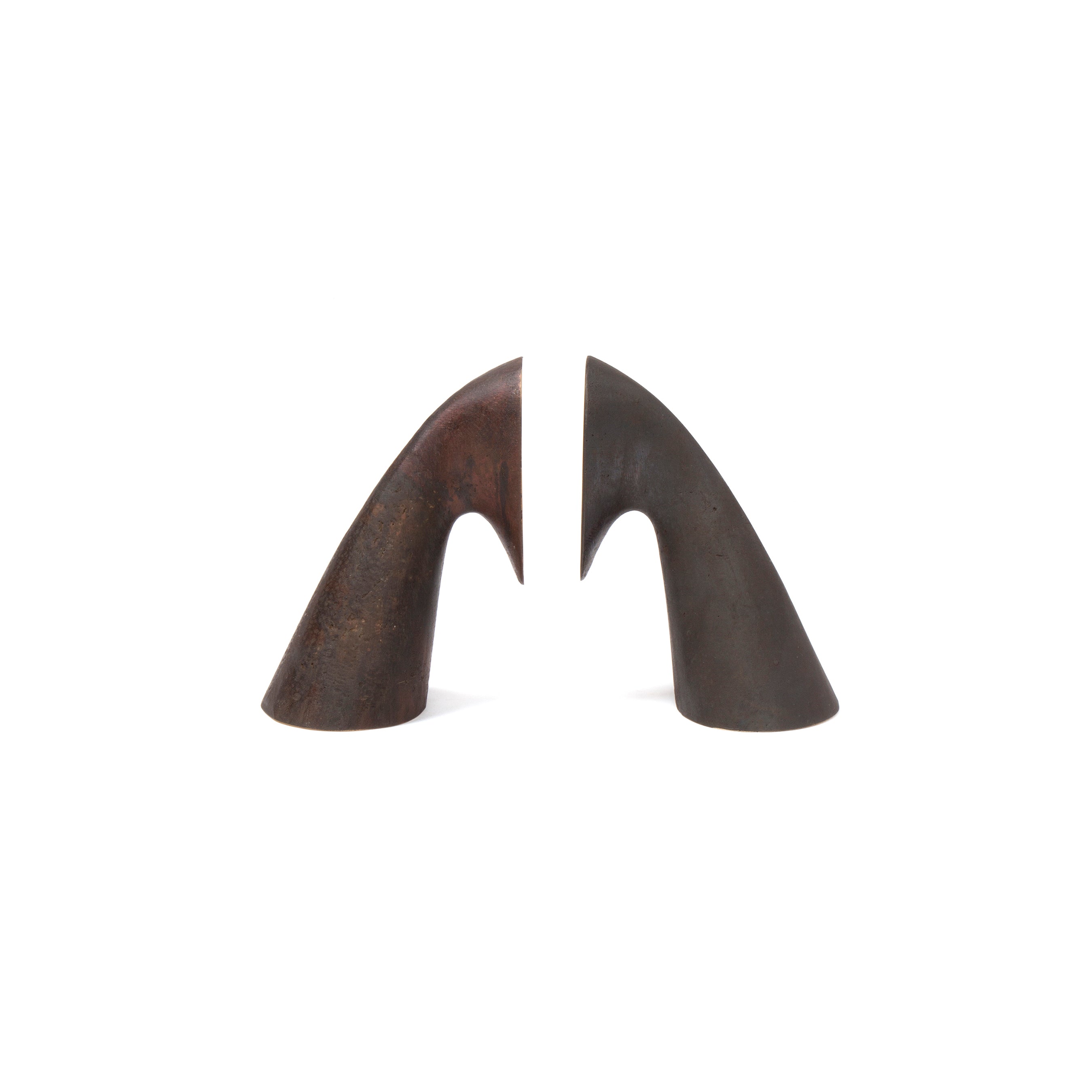 Two elegant, horn-like sculptures that resemble Werkstätte Carl Auböcks style are showcased against a plain white background. The Pair of bookends #3654 features one brown piece on the left and a darker grayish-brown one on the right, each tapering gracefully to a smooth, rounded point.