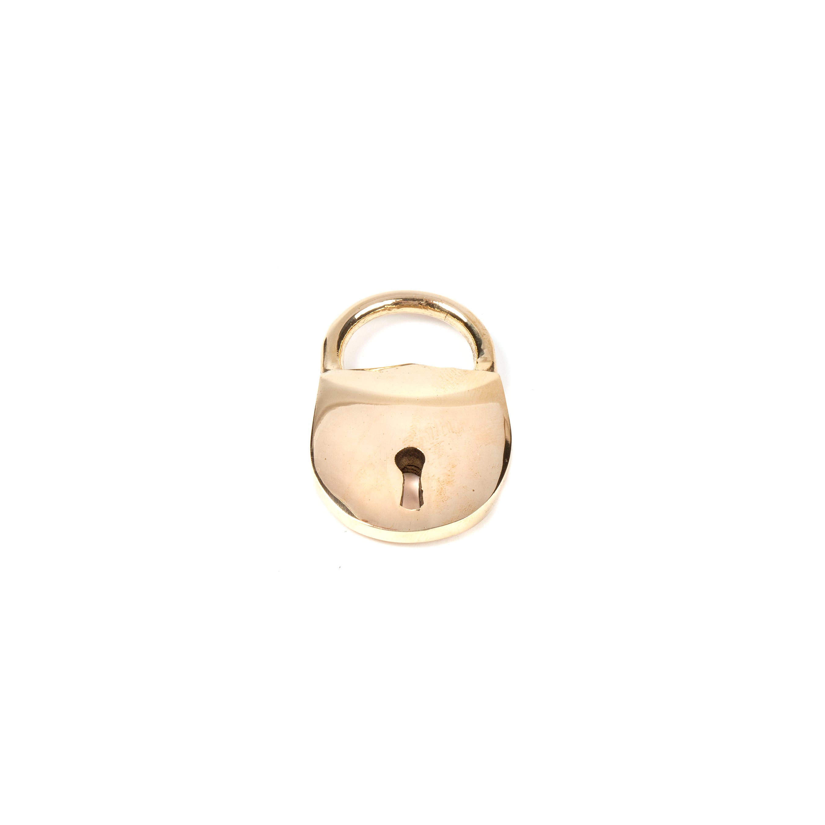 Close-up of the Bottle Opener Lock #4666 by Werkstätte Carl Auböck, a shiny brass padlock with a keyhole, reminiscent of Viennese townhouse craftsmanship, set against a plain white background.