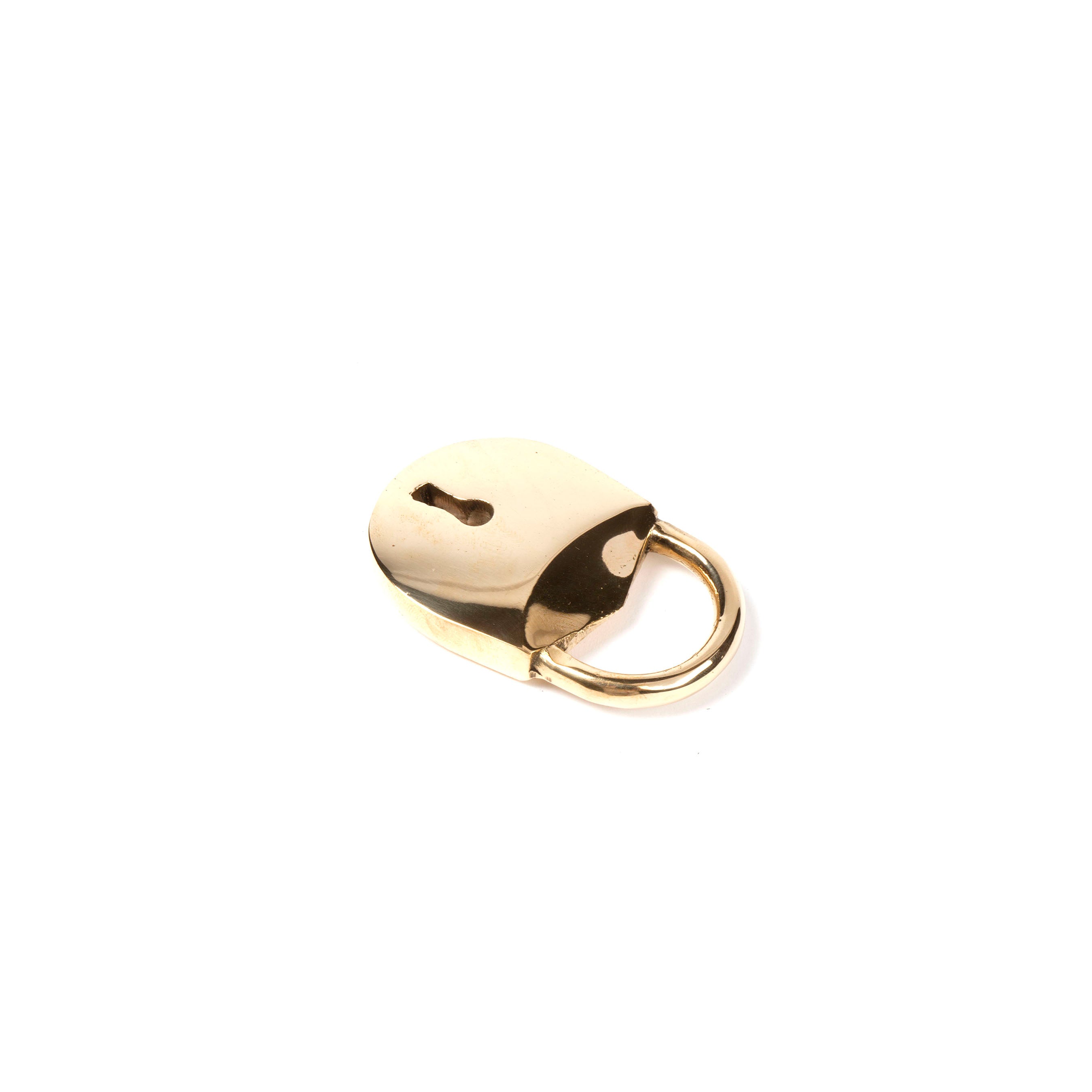 The Bottle Opener Lock #4666 by Werkstätte Carl Auböck, resembling a small gold padlock with a keyhole, sits flat on a white background. Its shiny metal mirrors Viennese townhouse elegance and timeless craftsmanship reminiscent of Wiener Bronzen.