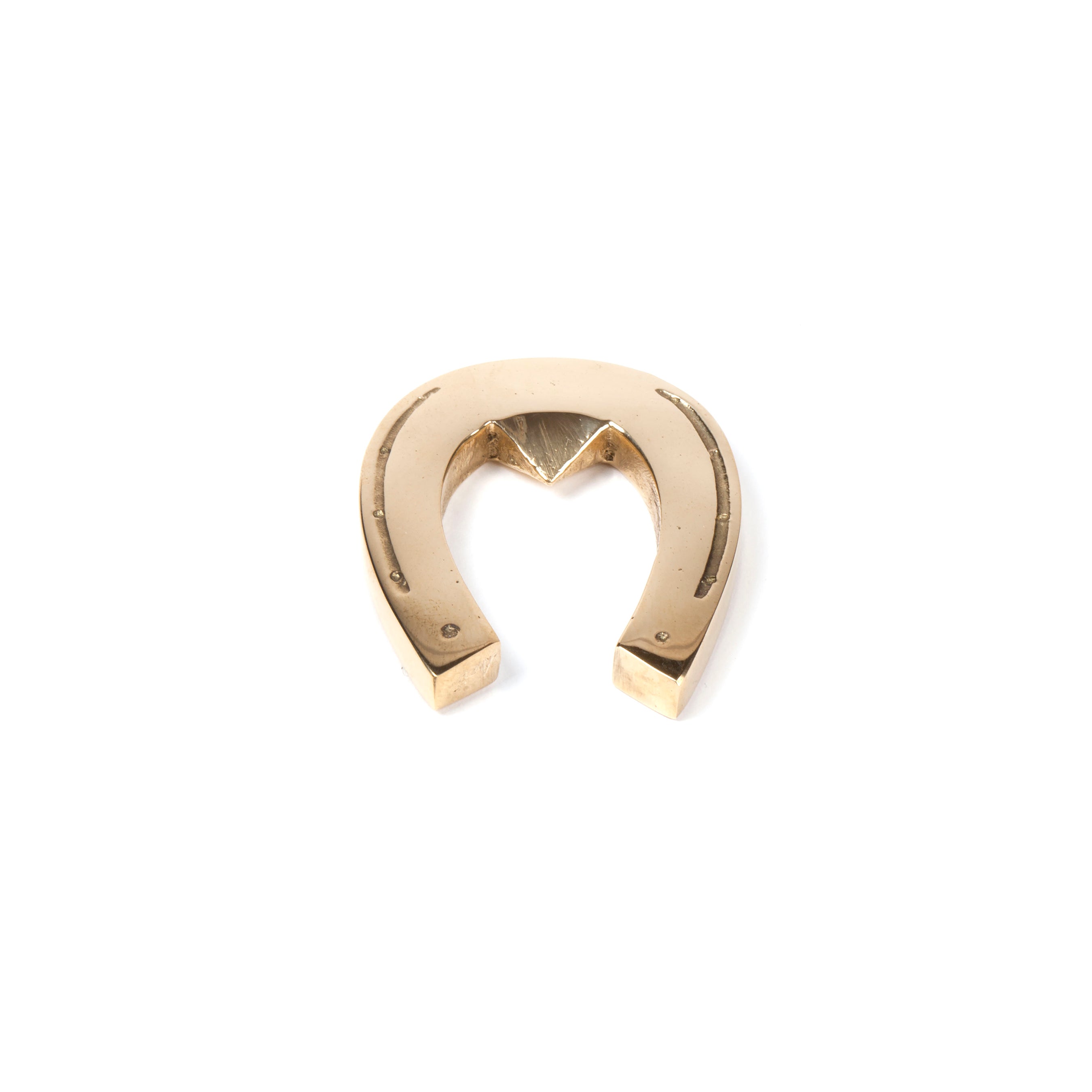 A Werkstätte Carl Auböck-inspired Bottle Opener Horseshoe #4675 is shown on a plain white background. Its upright position, with the open end facing downward, echoes Wiener Bronzen artistry with minimalist elegance.