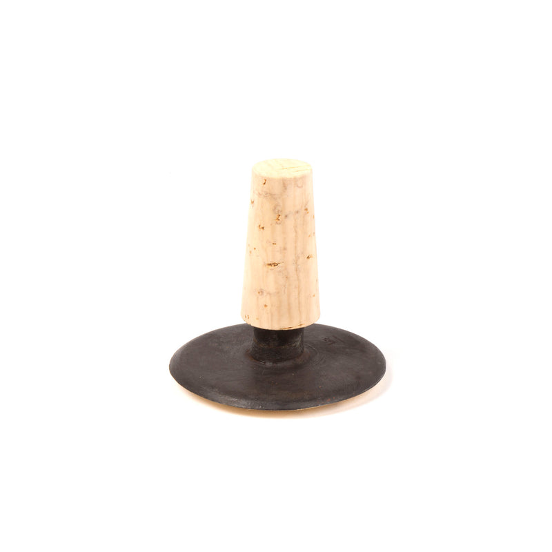 The Corkstopper Face #4682 by Werkstätte Carl Auböck is a vintage black rubber kitchen tool with a wide base and tapered light wooden handle, evocative of classic designs found in Viennese townhouses for food mashing or pressing.