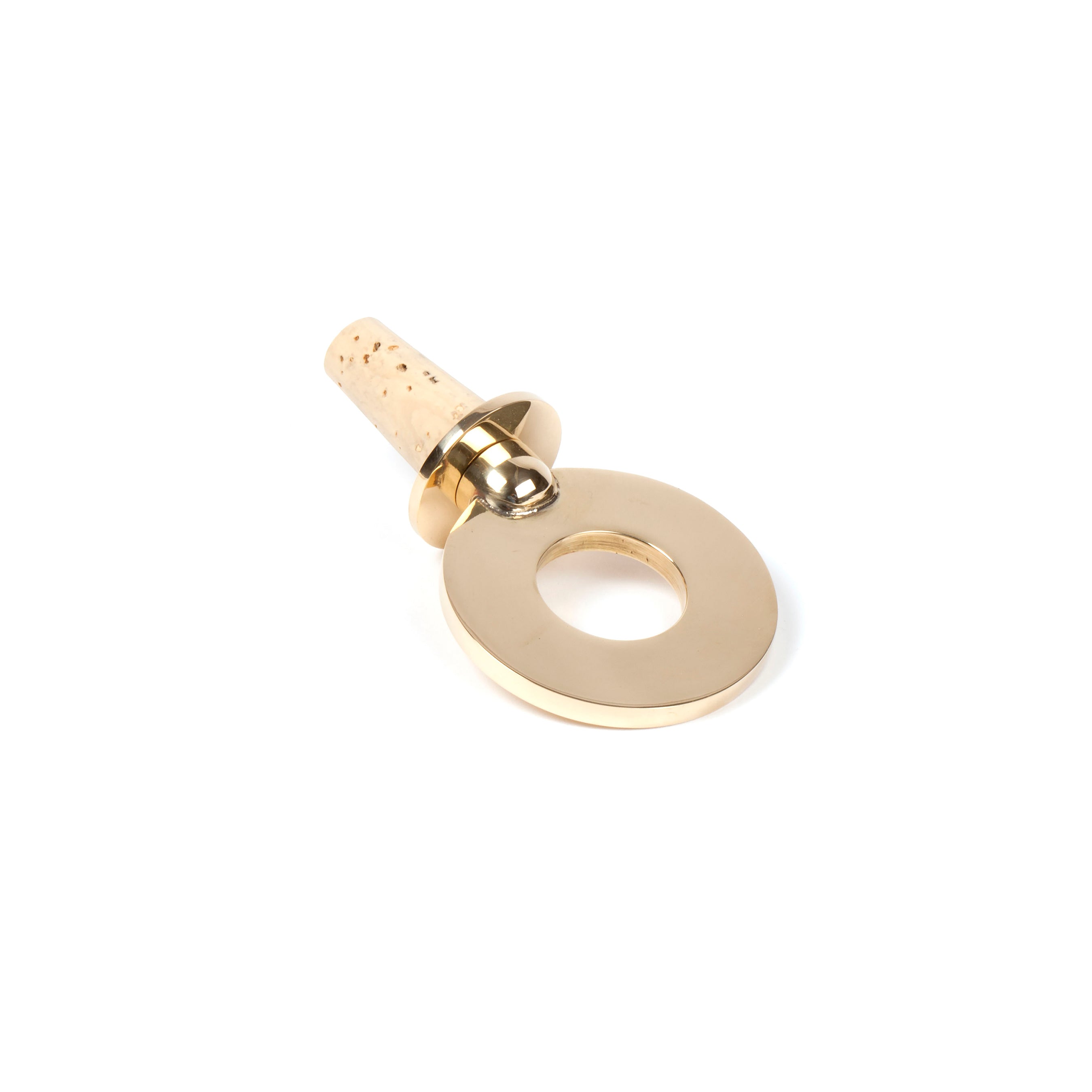 On a white backdrop, Corkstopper Ring #5971 from Werkstätte Carl Auböck showcases its gold, flat round handle with a conical cork end, reflecting the elegant craftsmanship that echoes the charm of a Viennese townhouse.