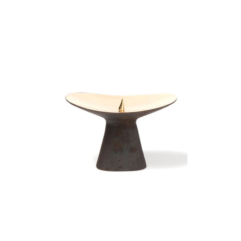 The Candlestick #3469 by Werkstätte Carl Auböck features a modern minimalist design with a wide, shallow cream dish on a dark, tapered cylindrical base, holding a single upright incense stick against a plain white background.