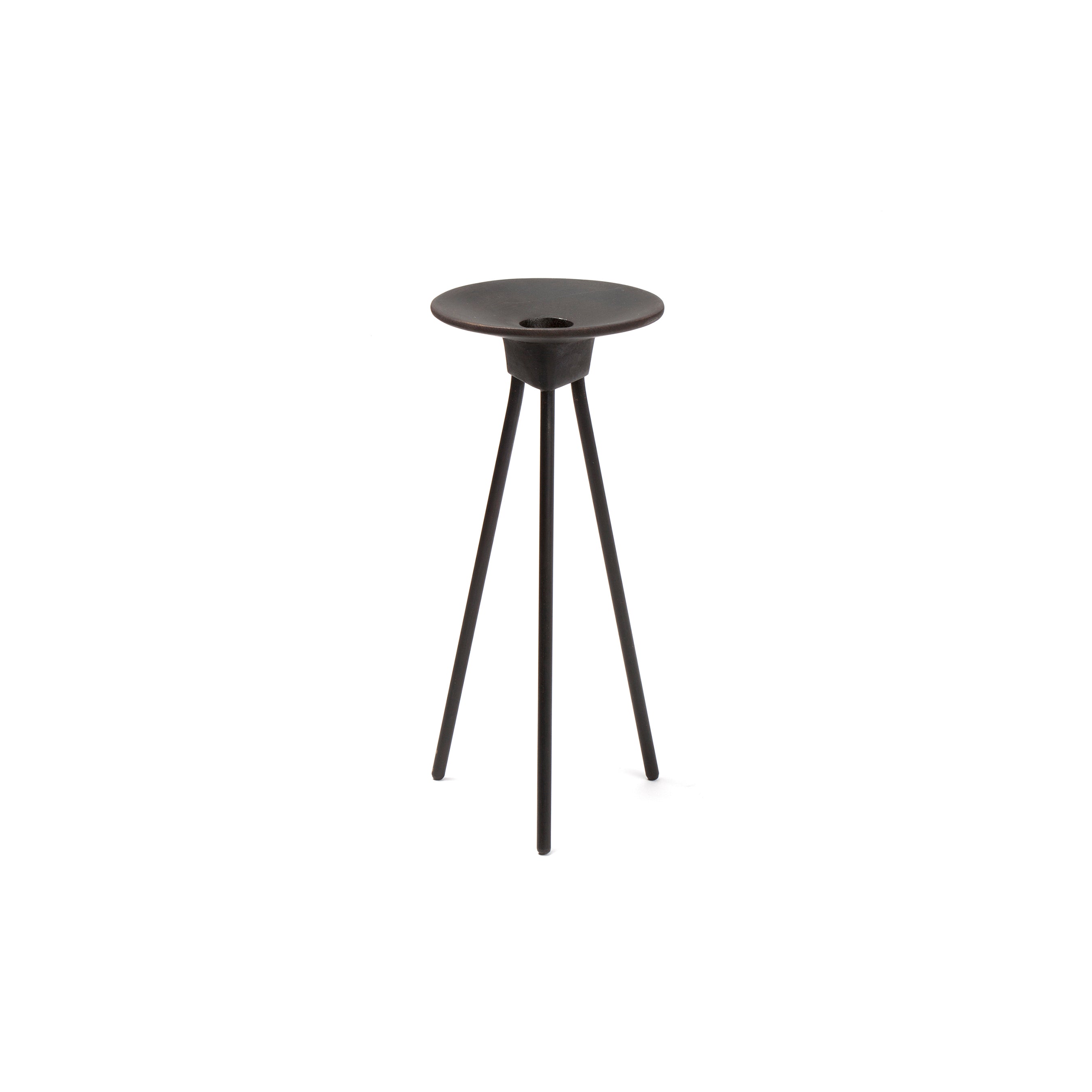 The Werkstätte Carl Auböck Candlestick #3980 is a sleek, modern black metal side table with a circular top, three slender legs, and a central indentation, embodying minimalist design inspired by Carl Auböck.