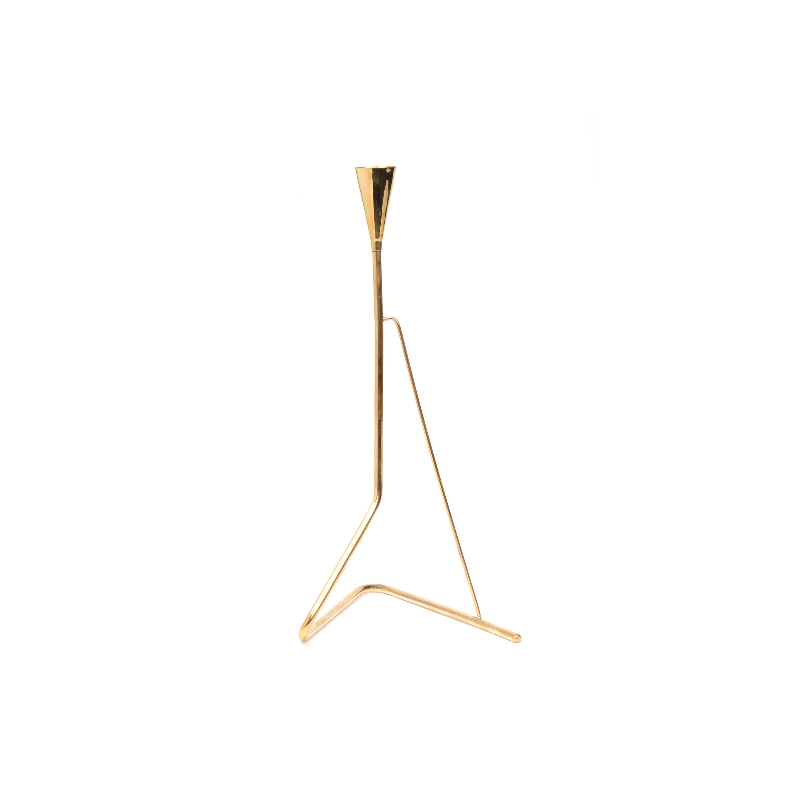 The Candlestick #4103 by Werkstätte Carl Auböck is a minimalist gold metal sculpture with a triangular base and slender vertical rod tapering to a point, elegantly set against a white background.