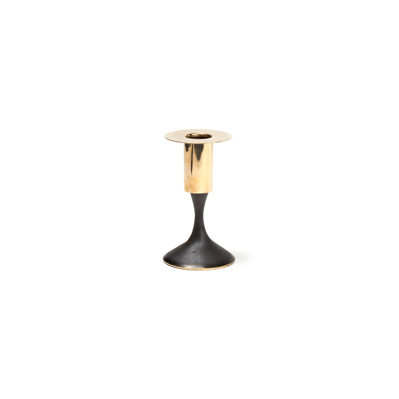 From Werkstätte Carl Auböck, the Set of 2 Candlesticks #7234 features polished brass holders on curvy black bases, set against a plain white background for a sleek, modern look.