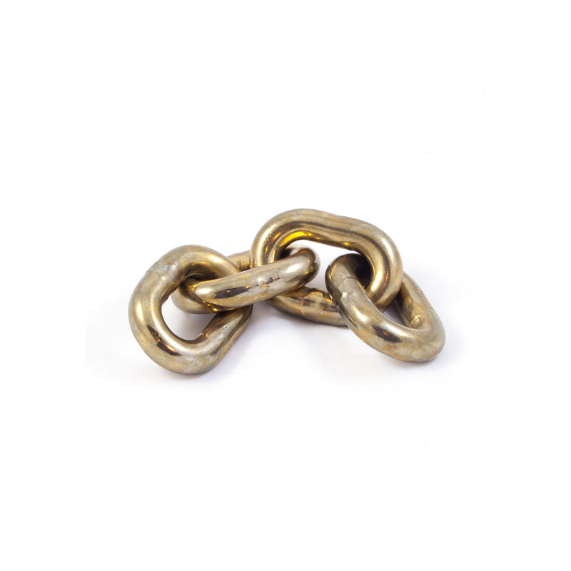 A close-up of three interconnected brass links from the Paperweight Chain #5072 by Werkstätte Carl Auböck, set against a plain white background.
