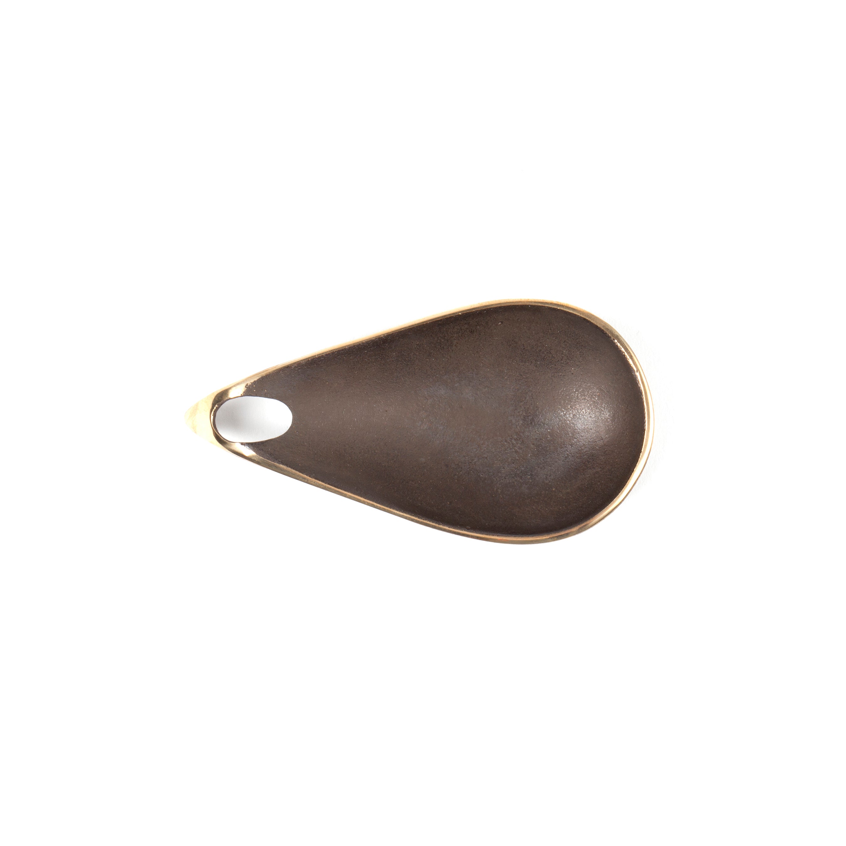 A close-up of Werkstätte Carl Auböcks bronze-colored Dish #3904, shaped like a teardrop with a small hole near the narrow end, evokes timeless Viennese elegance reminiscent of Carl Auböcks Wiener Bronzen designs, set against a plain white background.