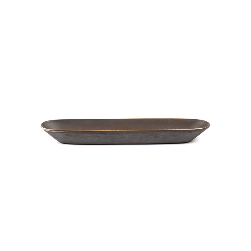 Dish #4317 by Werkstätte Carl Auböck is a rectangular, dark brown ceramic dish with slightly curved edges and a matte finish, echoing the artistry of a Viennese workshop. It sits empty against a plain white background.