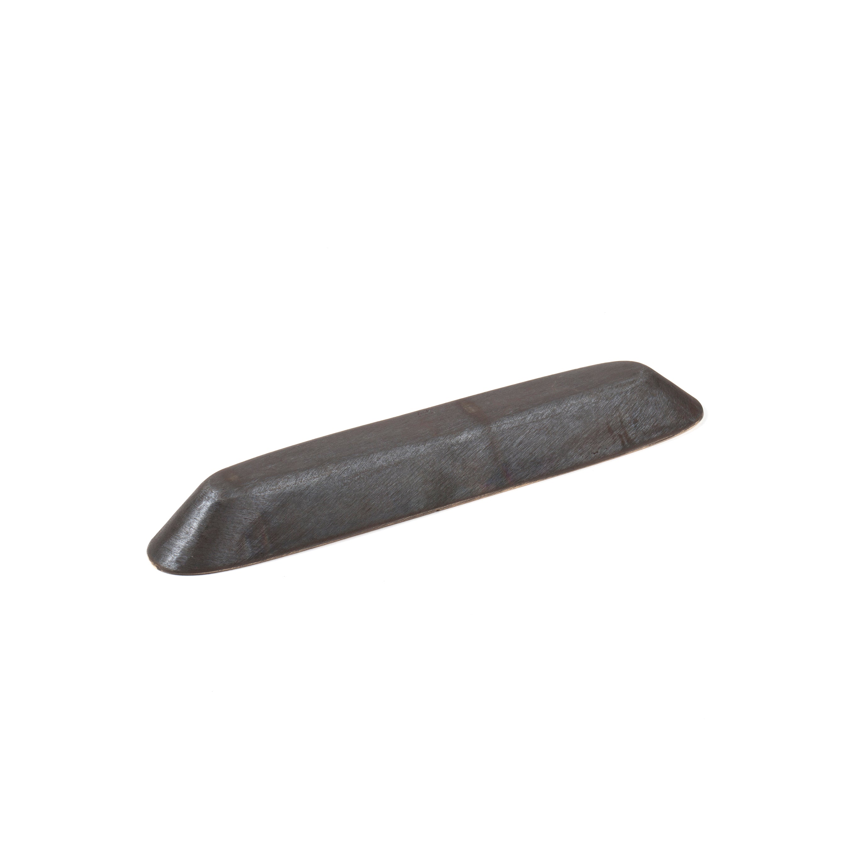 On a plain white background lies Dish #4317 from Werkstätte Carl Auböck, featuring a dark, elongated, and slightly curved shape with a smooth surface reminiscent of Wiener Bronzen craftsmanship.