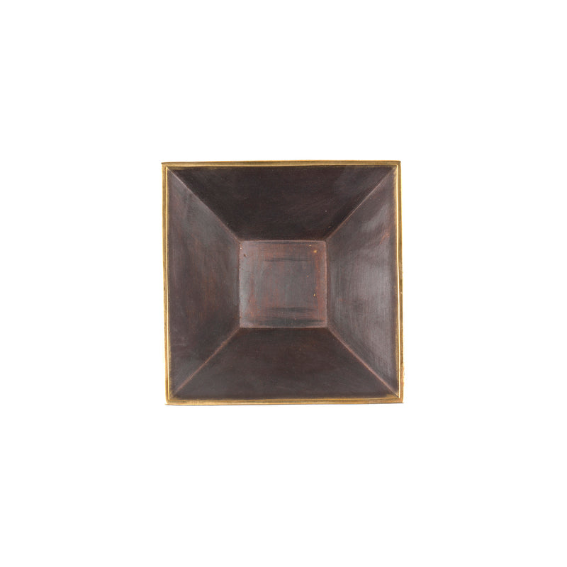 The Dish #4482 by Werkstätte Carl Auböck is a square black ceramic plate with a glossy finish and wide, slightly raised rim. Its minimalist design and subtle brown undertones are reminiscent of an Auböck aesthetic against a plain white background.