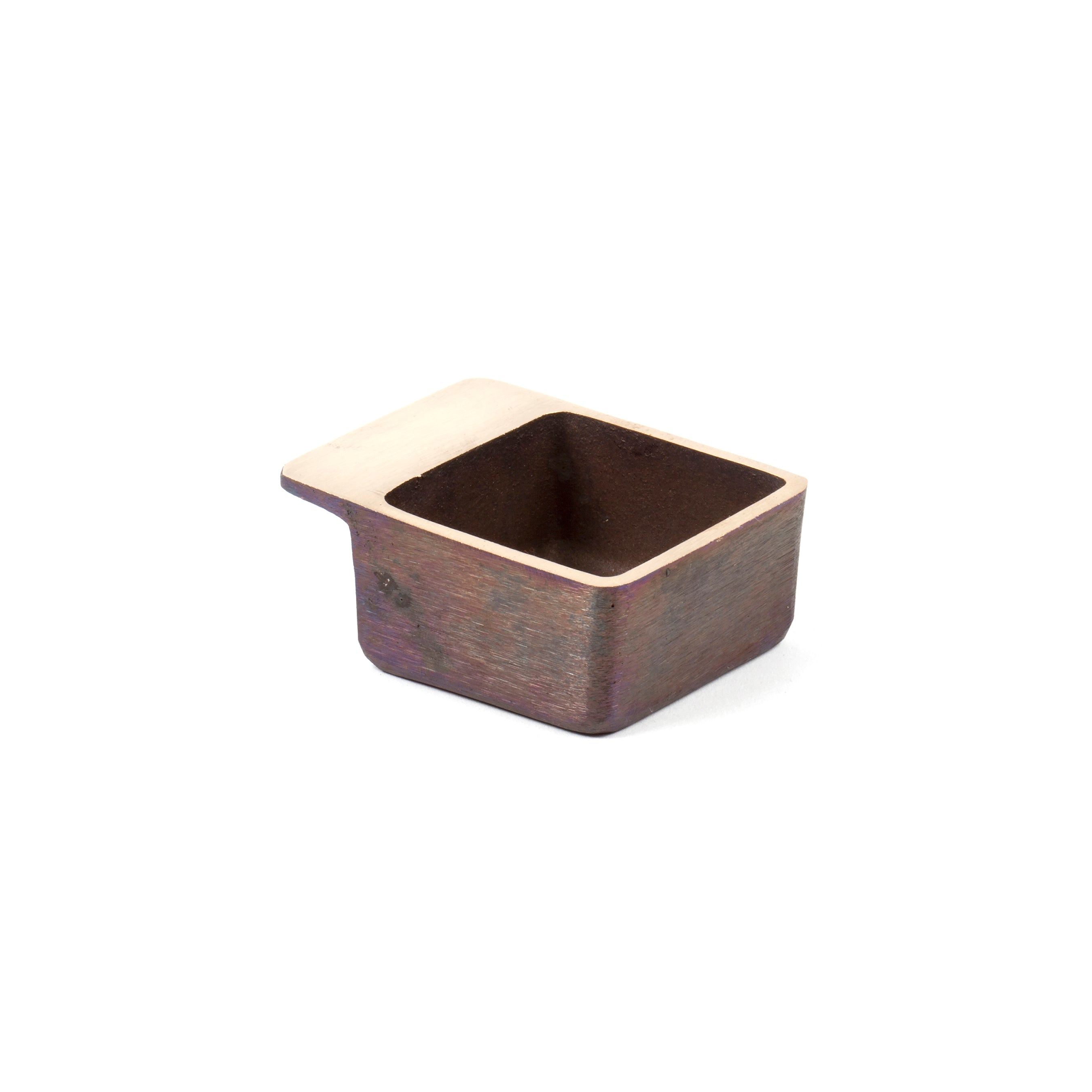 Ashtray #4610 by Werkstätte Carl Auböck: a small, square metallic ashtray with a textured surface and flat side handle, inspired by Viennese metalwork design, shown on a white background.