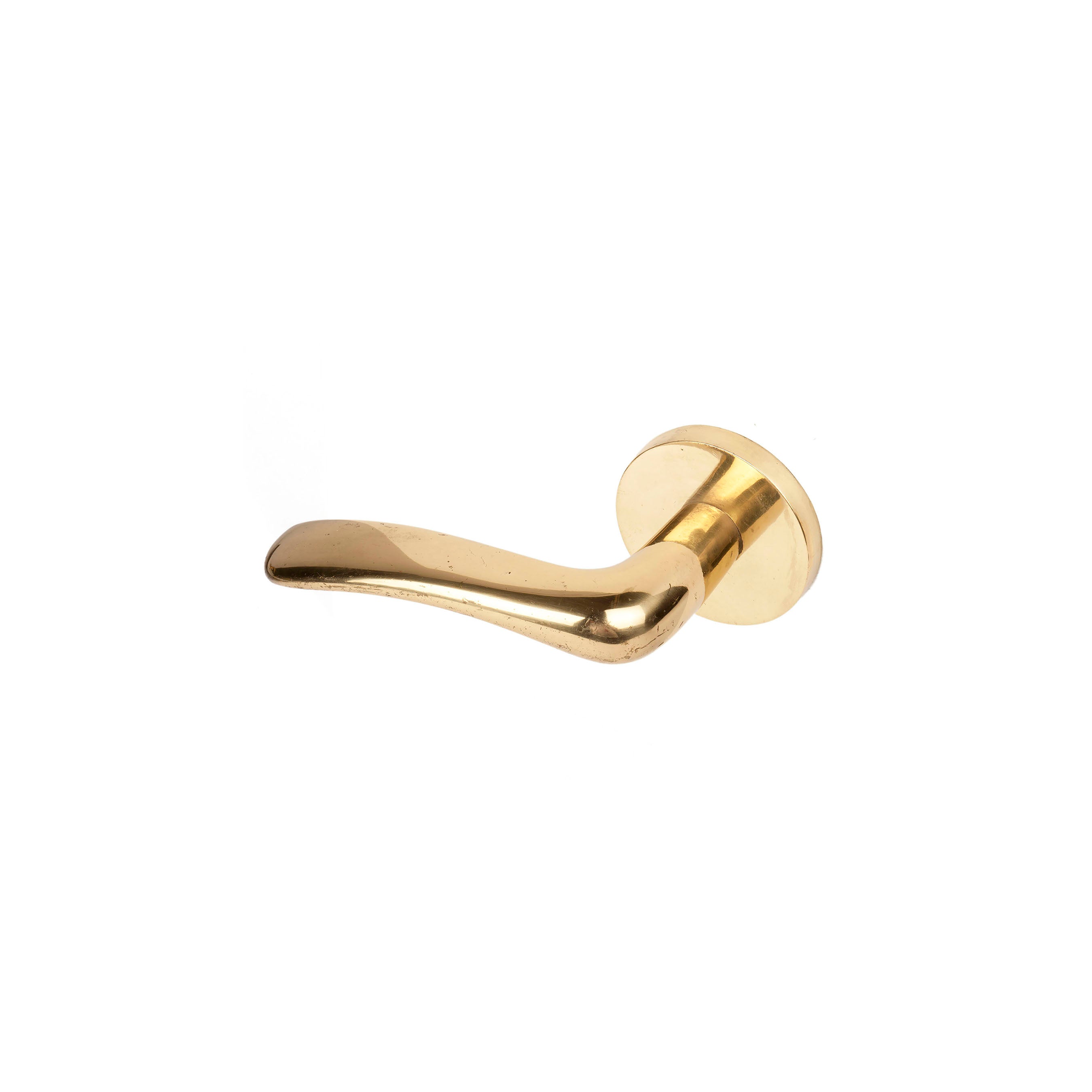 The Door Knob - Moon #8022-1 by Werkstätte Carl Auböck, with its sleek, gold-colored design and circular base, graces the entrance like a subtle nod to the elegance of a Viennese townhouse against the plain white backdrop.