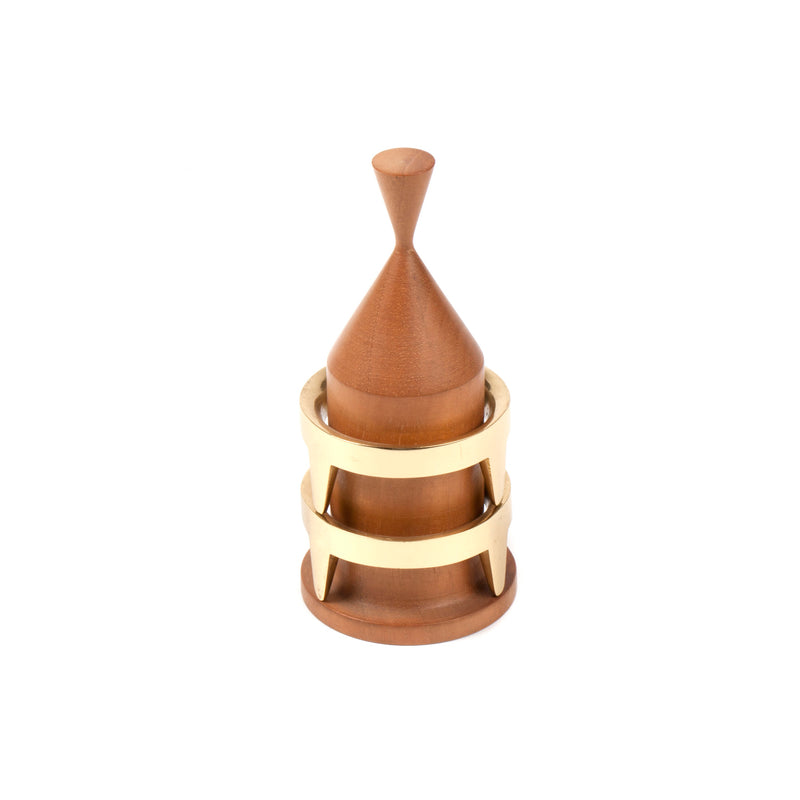 The Egg Cups Set #3697 by Werkstätte Carl Auböck features a wooden, cone-shaped design with a pointed top, accented by two brass rings on a round base. This piece embodies modern minimalism and doubles as an elegant egg cup, merging functionality with sophisticated style.