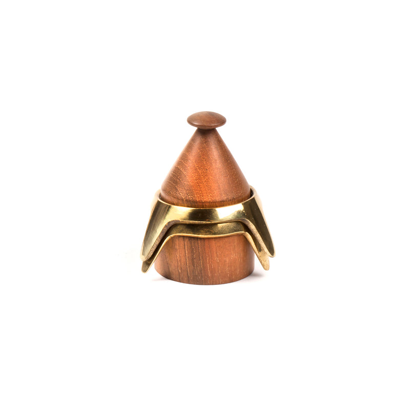 The Werkstätte Carl Auböck Egg Cup #4153-1 is a small wooden container with a conical lid and a bronze-colored metal band, reminiscent of a decorative keepsake box in a Viennese townhouse.