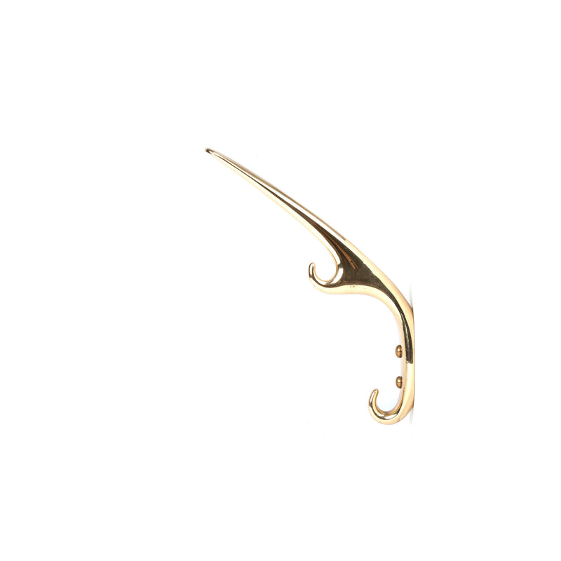 The Set of 3 Hooks #5439 from Werkstätte Carl Auböck is a sleek, gold-colored, metal wall hook with a long, elegant curve and two prongs. Its design, resembling accents from a Viennese townhouse, is beautifully contrasted against a plain white background.